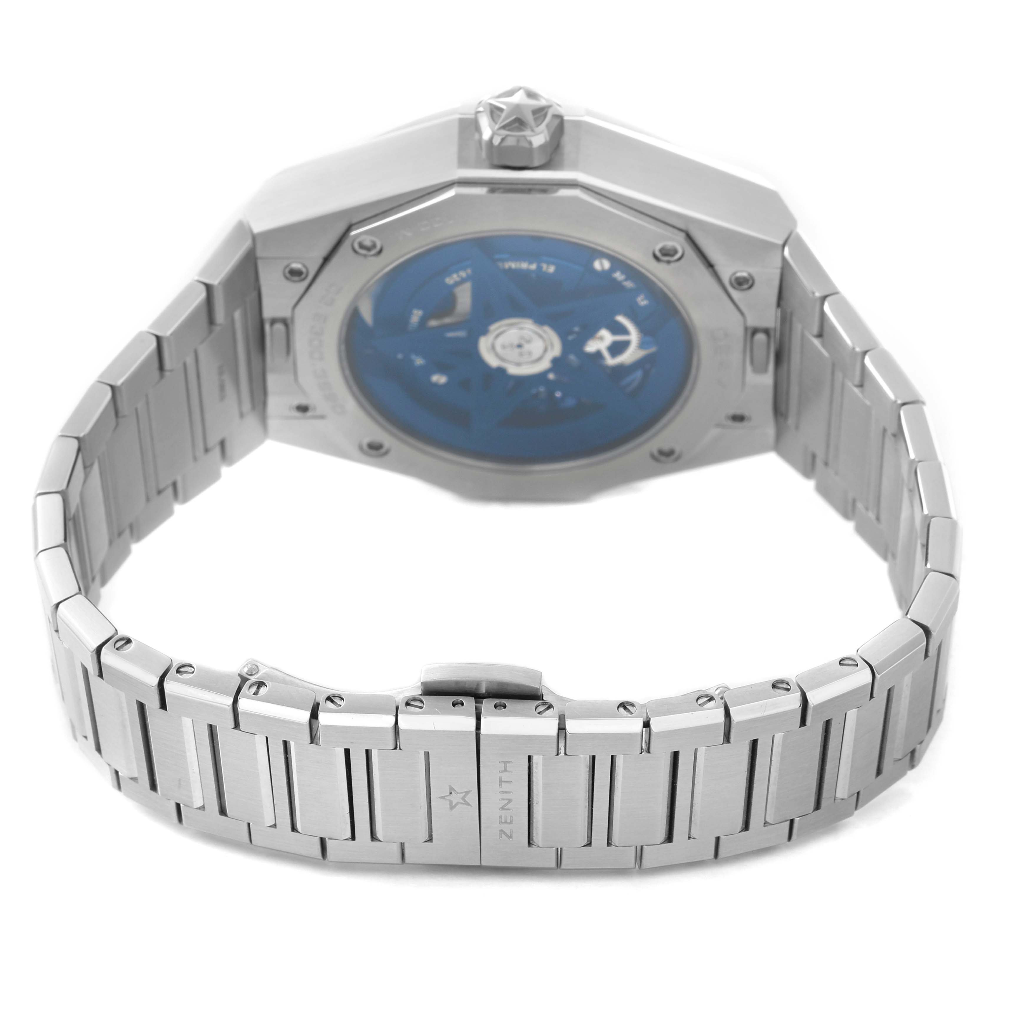 The image shows the back view of a Zenith Defy 03.9300.3620 / 79.I001 Men's Stainless Steel Blue Dial watch, highlighting the metal bracelet and transparent case back.