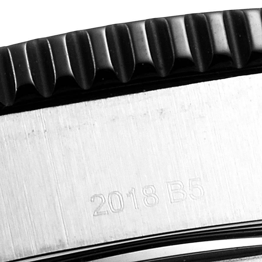The image shows a close-up of the side of a Breitling Superocean Y17393 Men's Stainless Steel Black Dial Y17393 Men's Stainless Steel Black Dial watch, highlighting the bezel and part of the case with an engraved marking.