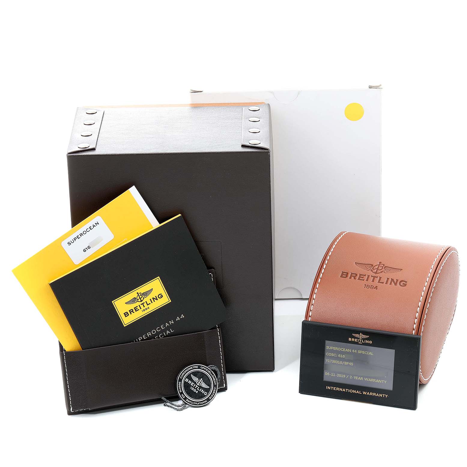 The image depicts the Breitling Superocean Y17393 Men's Stainless Steel Black Dial Y17393 Men's Stainless Steel Black Dial watch box, instruction manuals, a leather case, and warranty card.