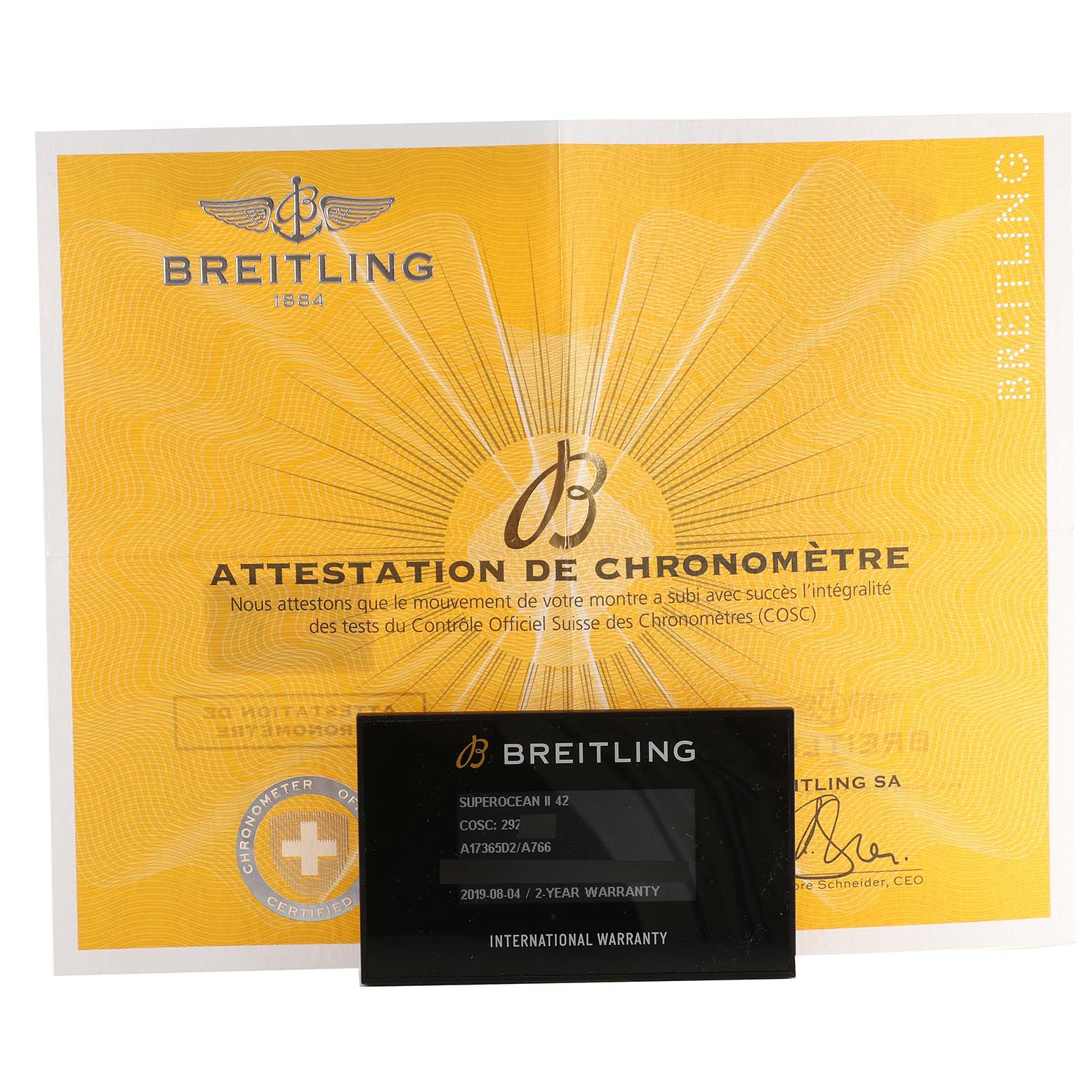 The image shows a Breitling Superocean A17365 Men's Stainless Steel White Dial A17365 Men's Stainless Steel White Dial model's certificate and warranty card against a flat angle.