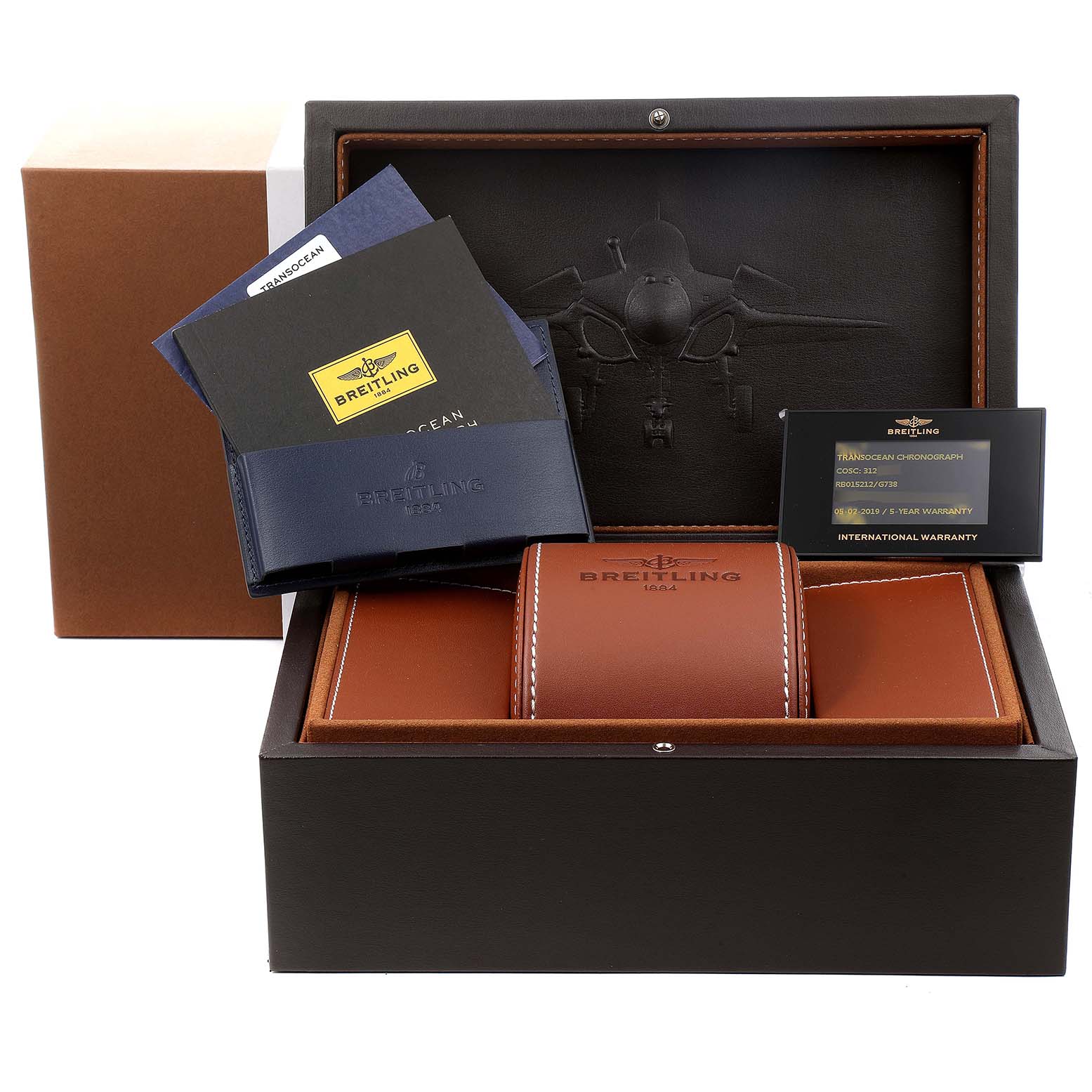 The image shows a Breitling Transocean RB0152 Men's Rose Gold Silver Dial RB0152 Men's Rose Gold Silver Dial watch box and accessories, including manuals, a warranty card, and a watch case.