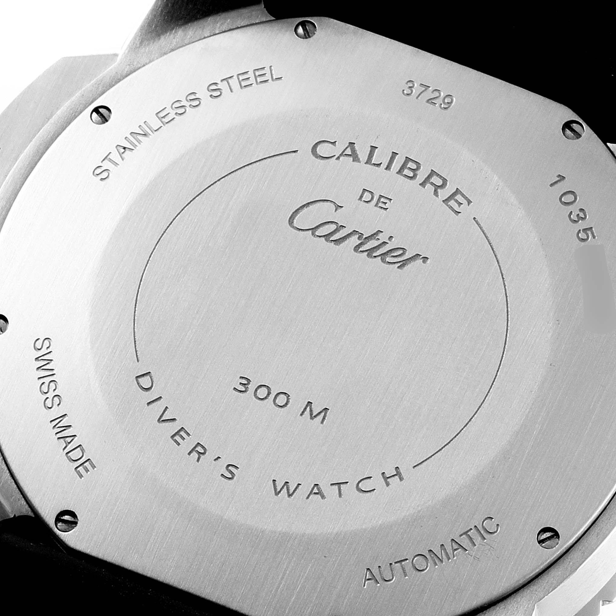 The image shows the back case of the Calibre de Cartier watch, highlighting its specifications and markings.