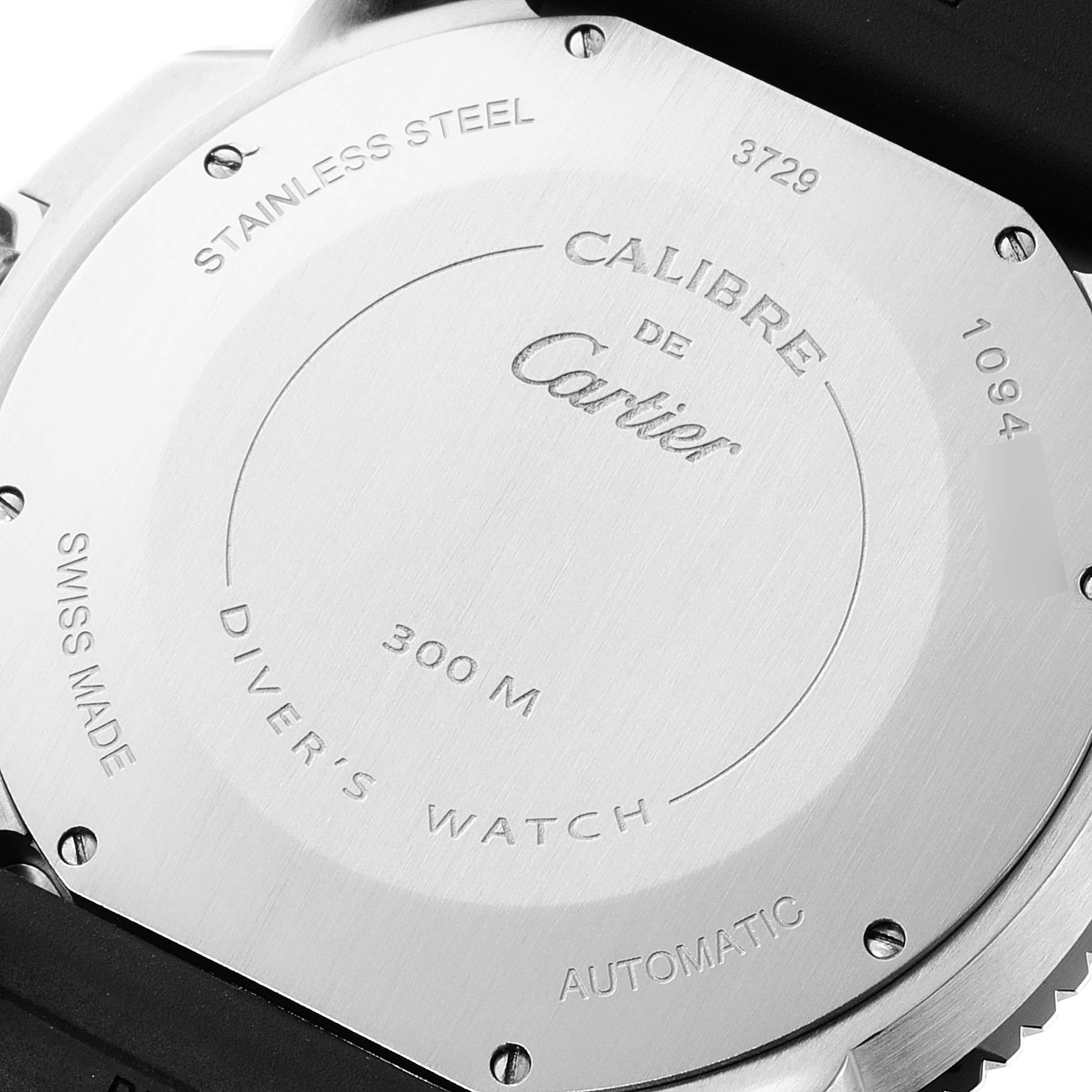 The image shows the stainless steel back case of a Calibre de Cartier watch by Cartier, highlighting details like water resistance and model information.