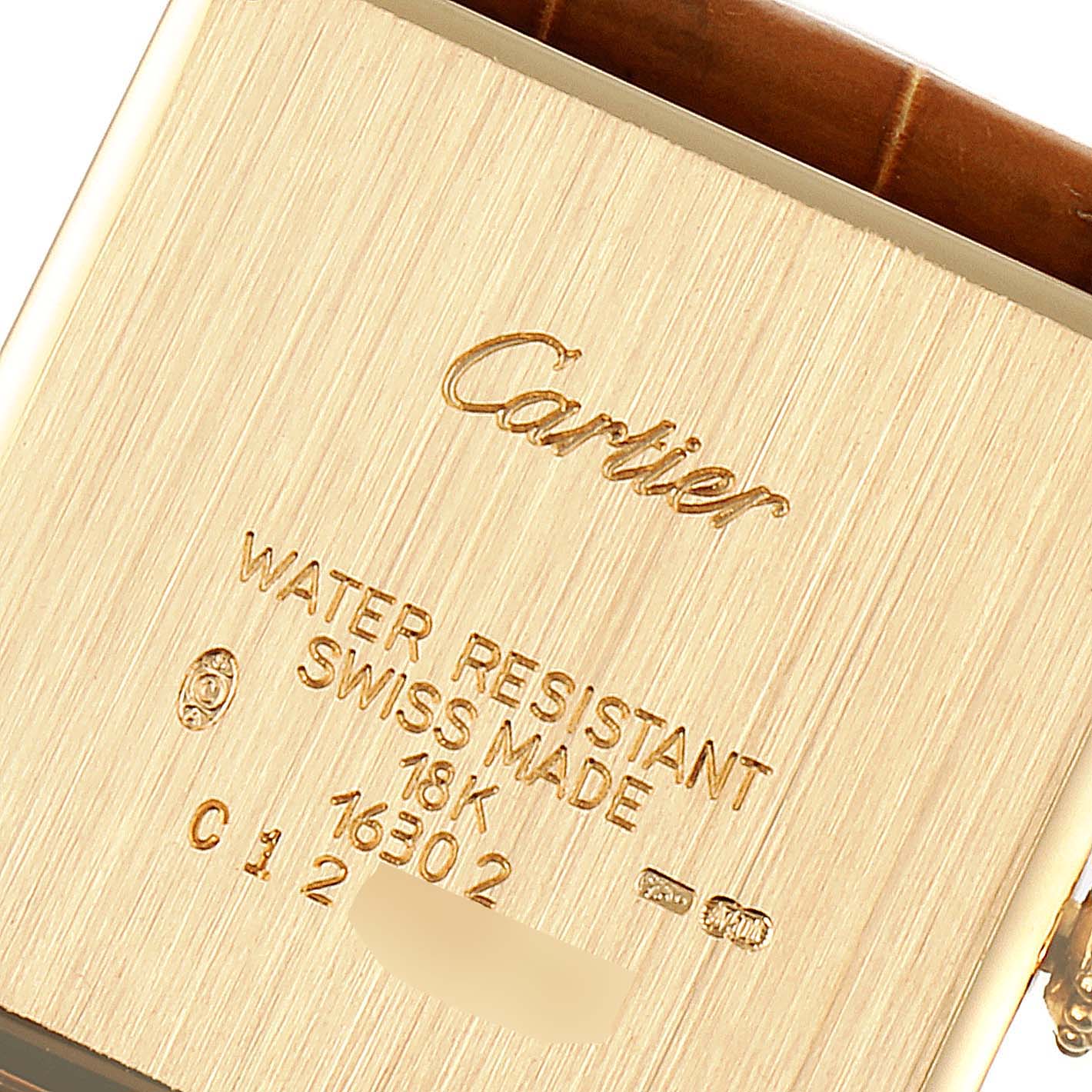 This is the back of a Cartier Tank Obus 1630 Women's Yellow Gold Silver Dial 1630 Women's Yellow Gold Silver Dial watch displaying the brand name, model details, and material specifications.