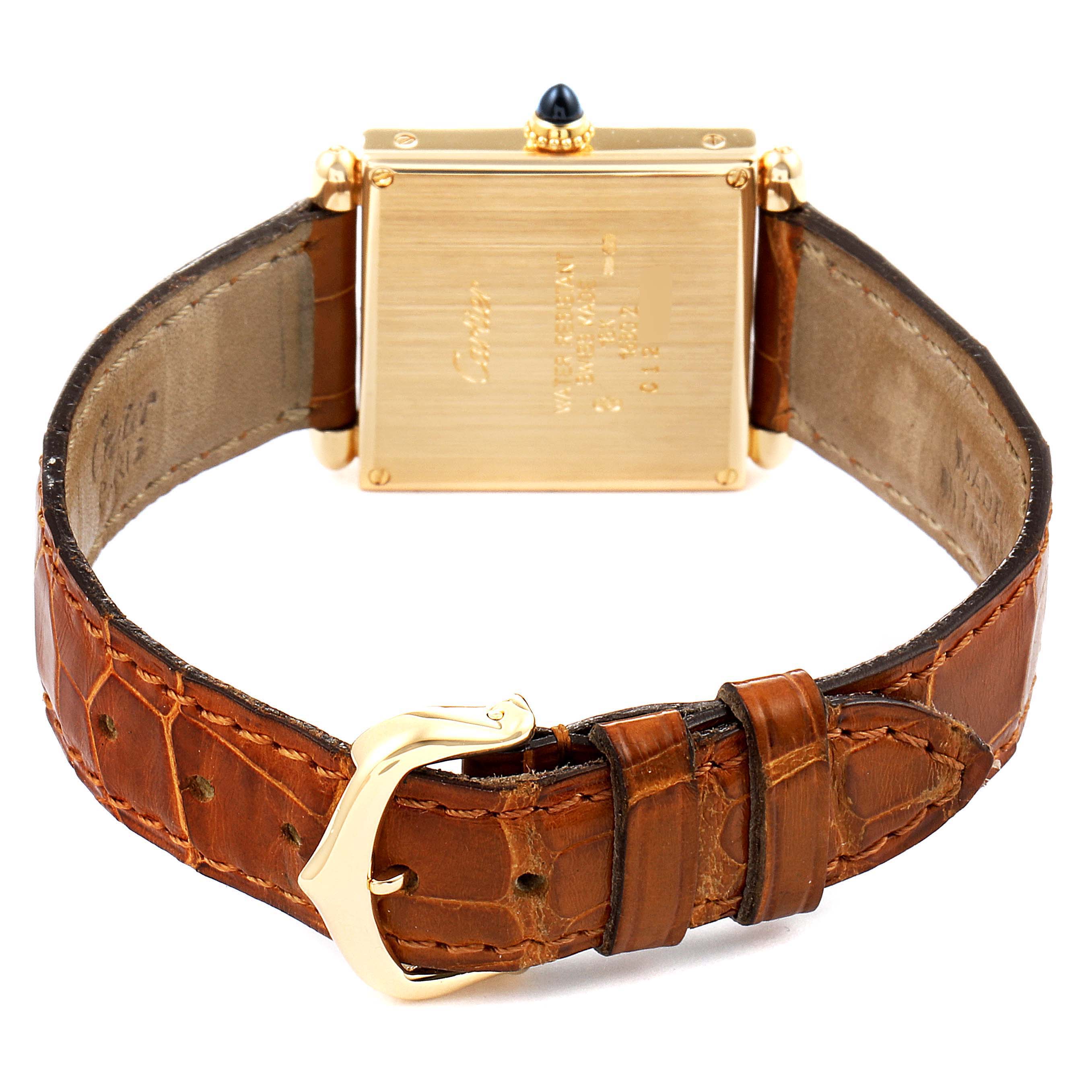 The image shows the back of the Cartier Tank Obus 1630 Women's Yellow Gold Silver Dial 1630 Women's Yellow Gold Silver Dial watch, highlighting its brown leather strap and gold buckle.