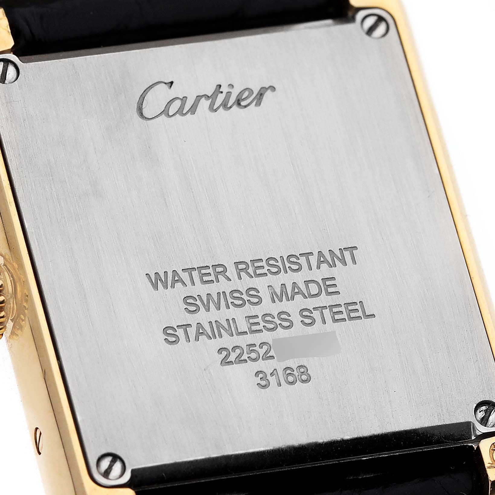 This image shows the backside of the Tank Solo model by Cartier, highlighting the brand engraving and water resistance details.