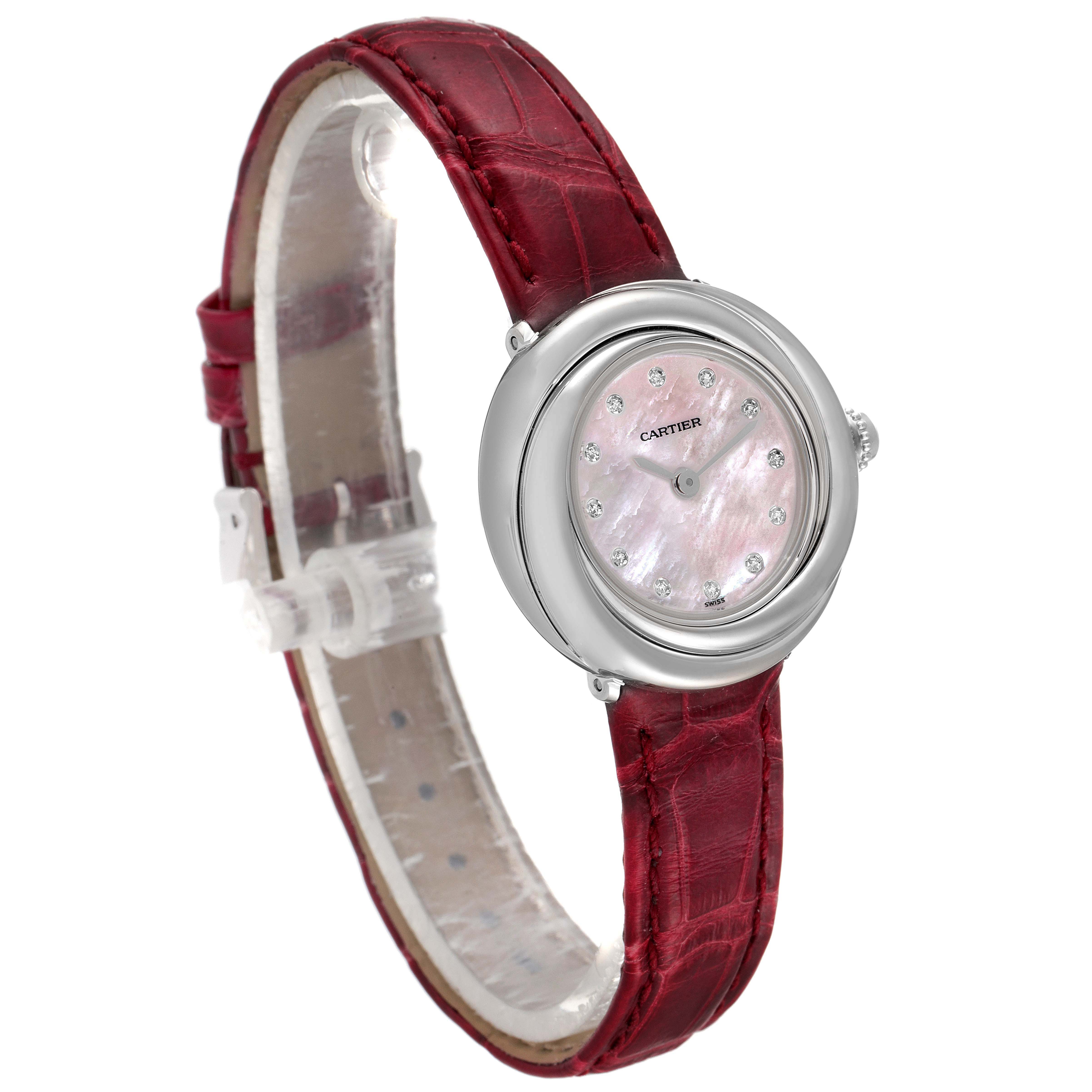The Cartier Trinity WG200846 Women's White Gold Mother of Pearl Dial WG200846 Women's White Gold Mother of Pearl Dial model watch is shown from a side angle, highlighting its red leather strap and round, diamond-studded dial.
