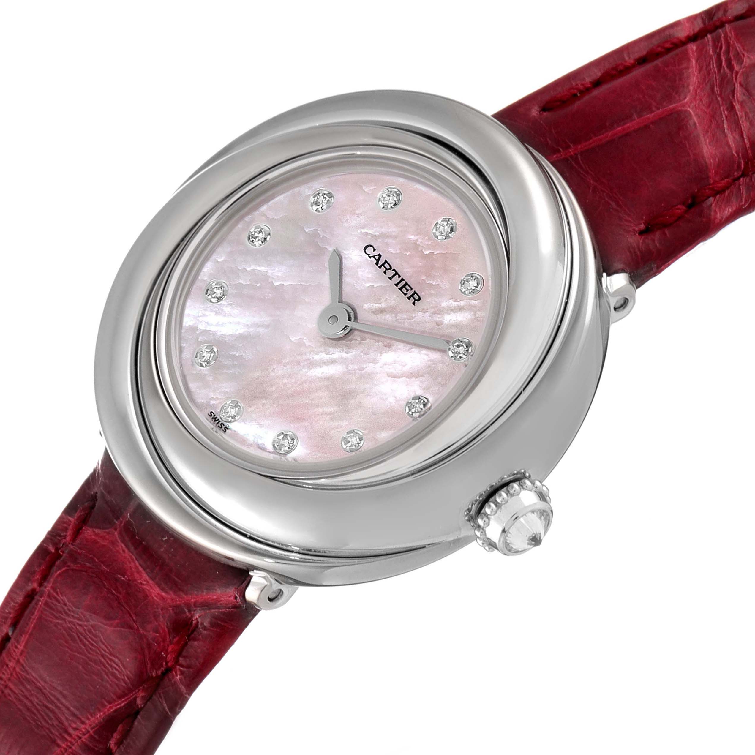 The Cartier Trinity WG200846 Women's White Gold Mother of Pearl Dial WG200846 Women's White Gold Mother of Pearl Dial model watch is shown from an angled perspective highlighting its dial with diamond markers, bezel, and red strap.
