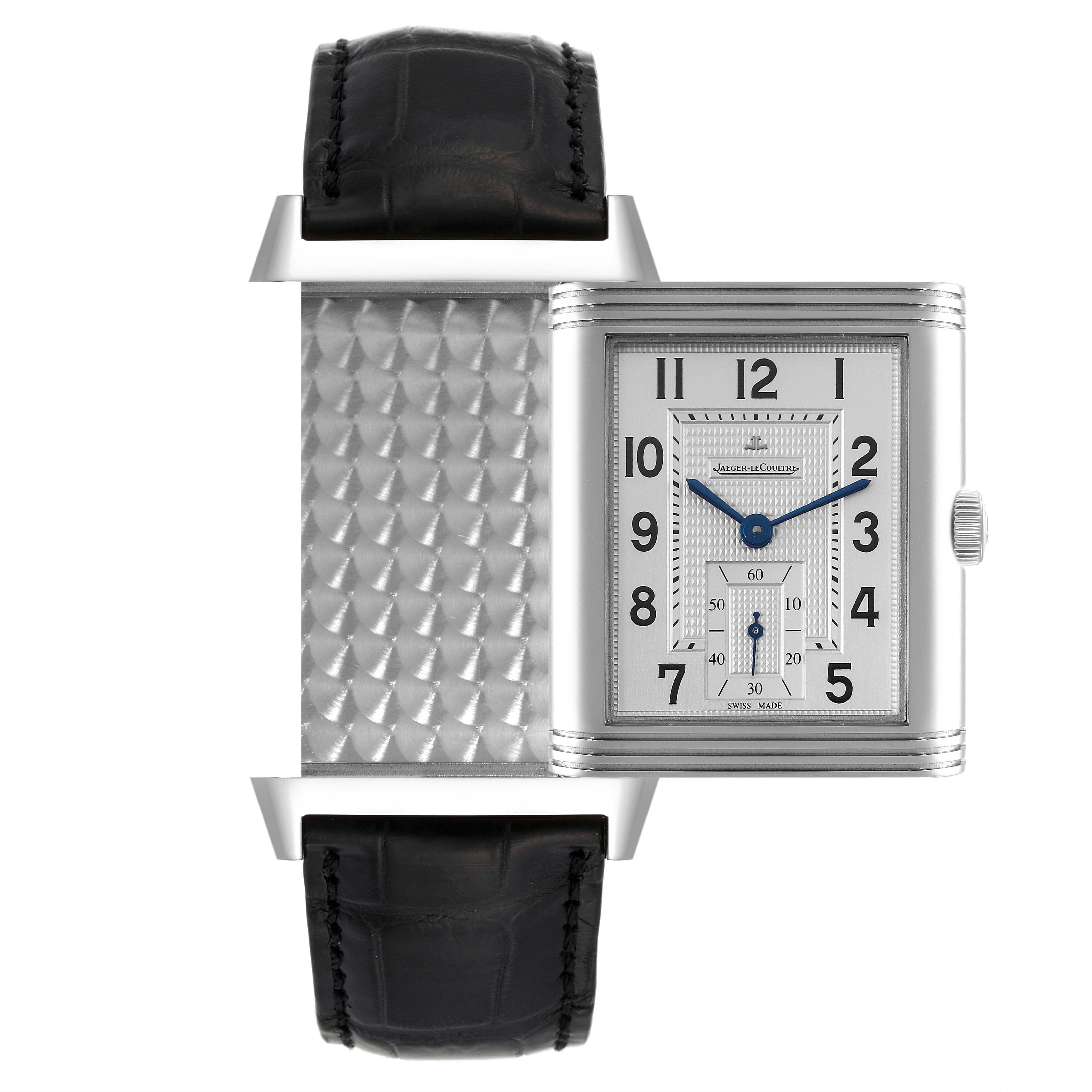 The image shows a Jaeger-LeCoultre Reverso watch with its face swiveled to reveal the decorative caseback.