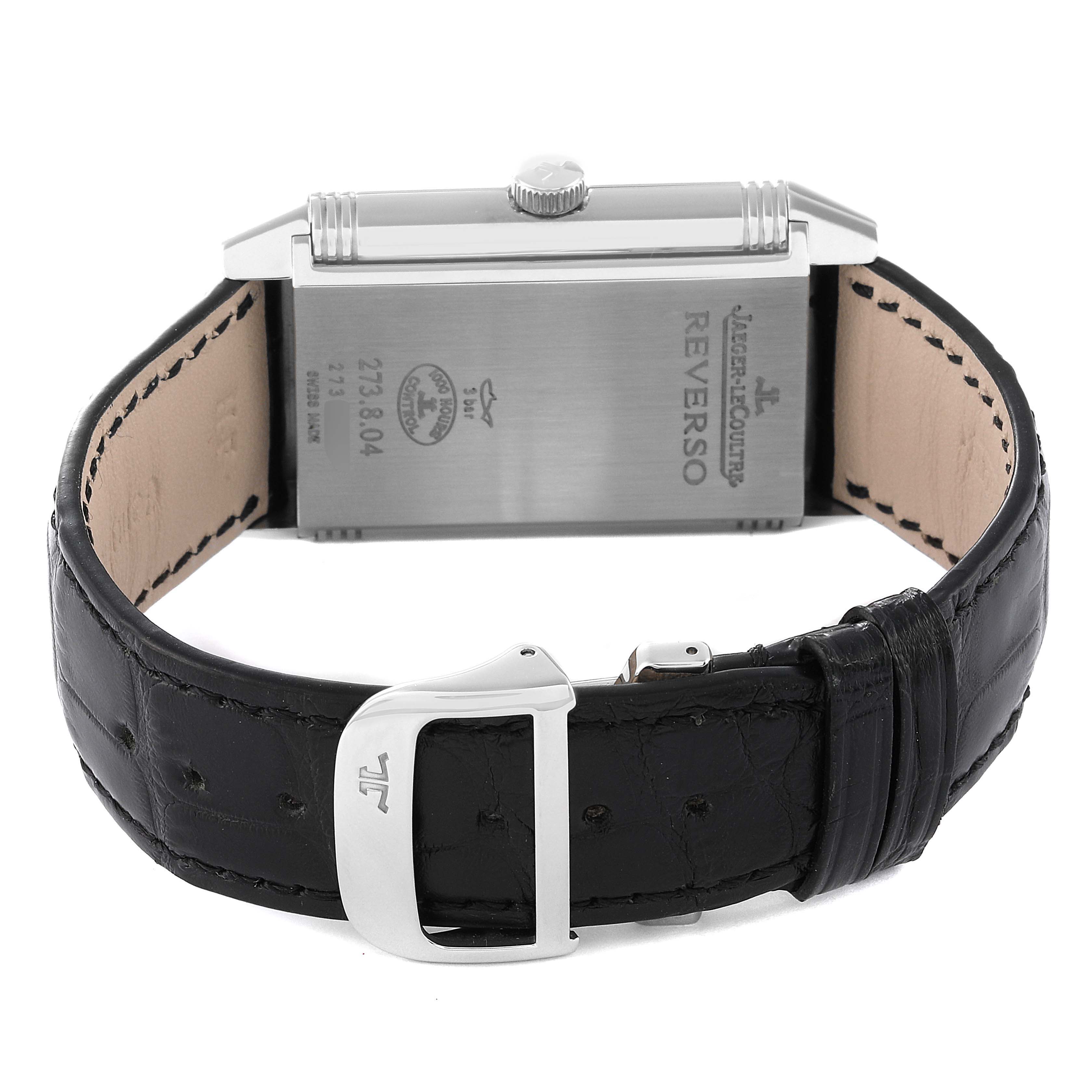This image shows the back and strap of a Jaeger-LeCoultre Reverso watch, including the buckle and engraved case back.