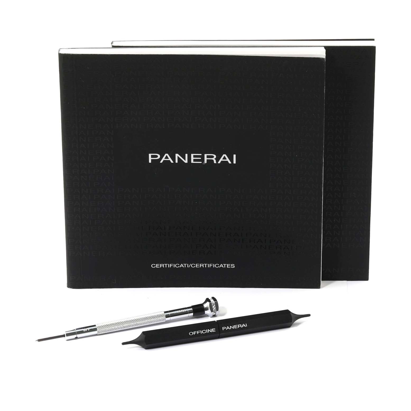 The image shows certification booklets and tools for a Panerai Luminor PAM01535 Men's Stainless Steel Black Dial PAM01535 Men's Stainless Steel Black Dial watch, viewed from a front angle.