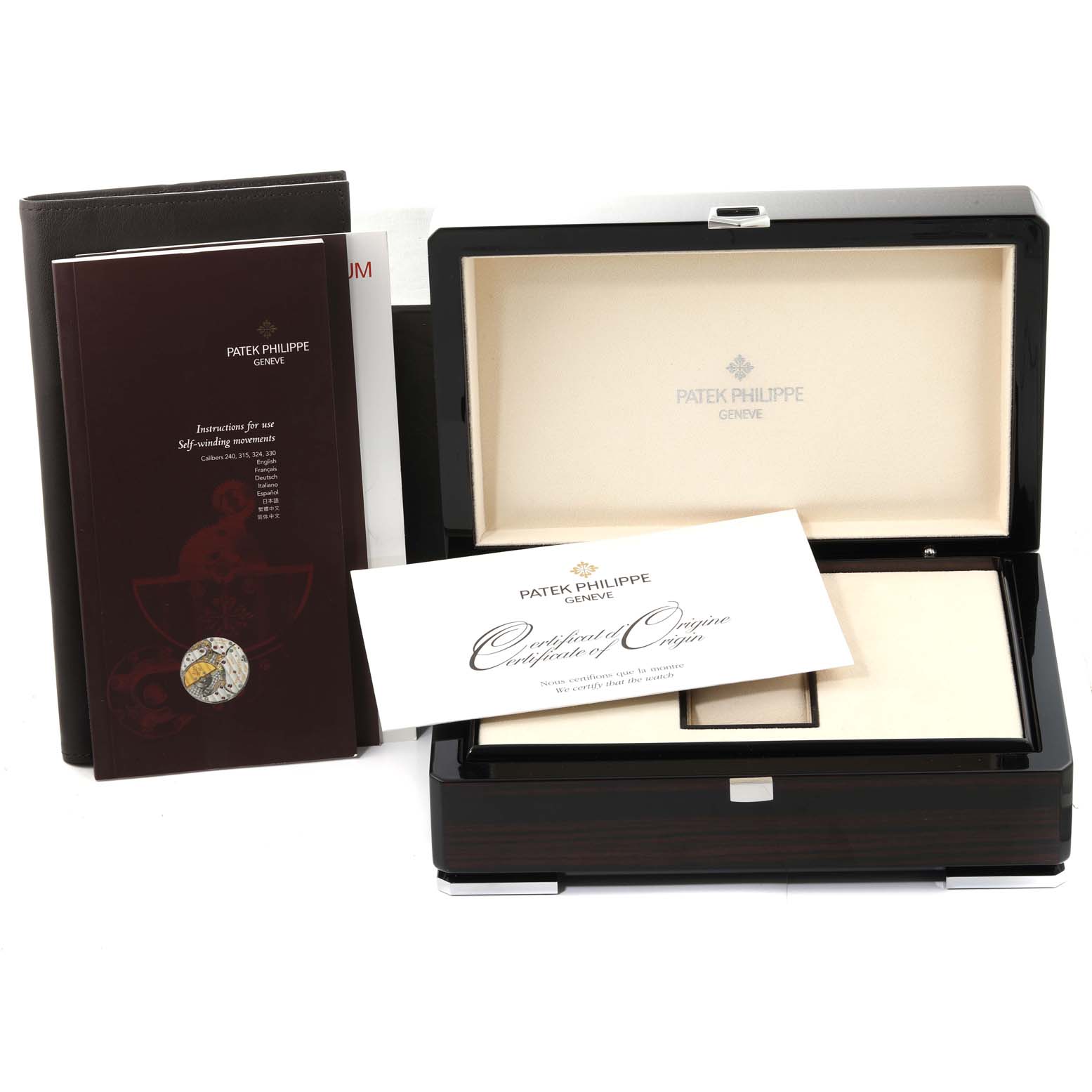 The image shows the packaging accessories for a Patek Philippe Aquanaut 5167R-001 Men's Rose Gold Brown Dial 5167R-001 Men's Rose Gold Brown Dial, including the presentation box, certificate, and instruction manuals.