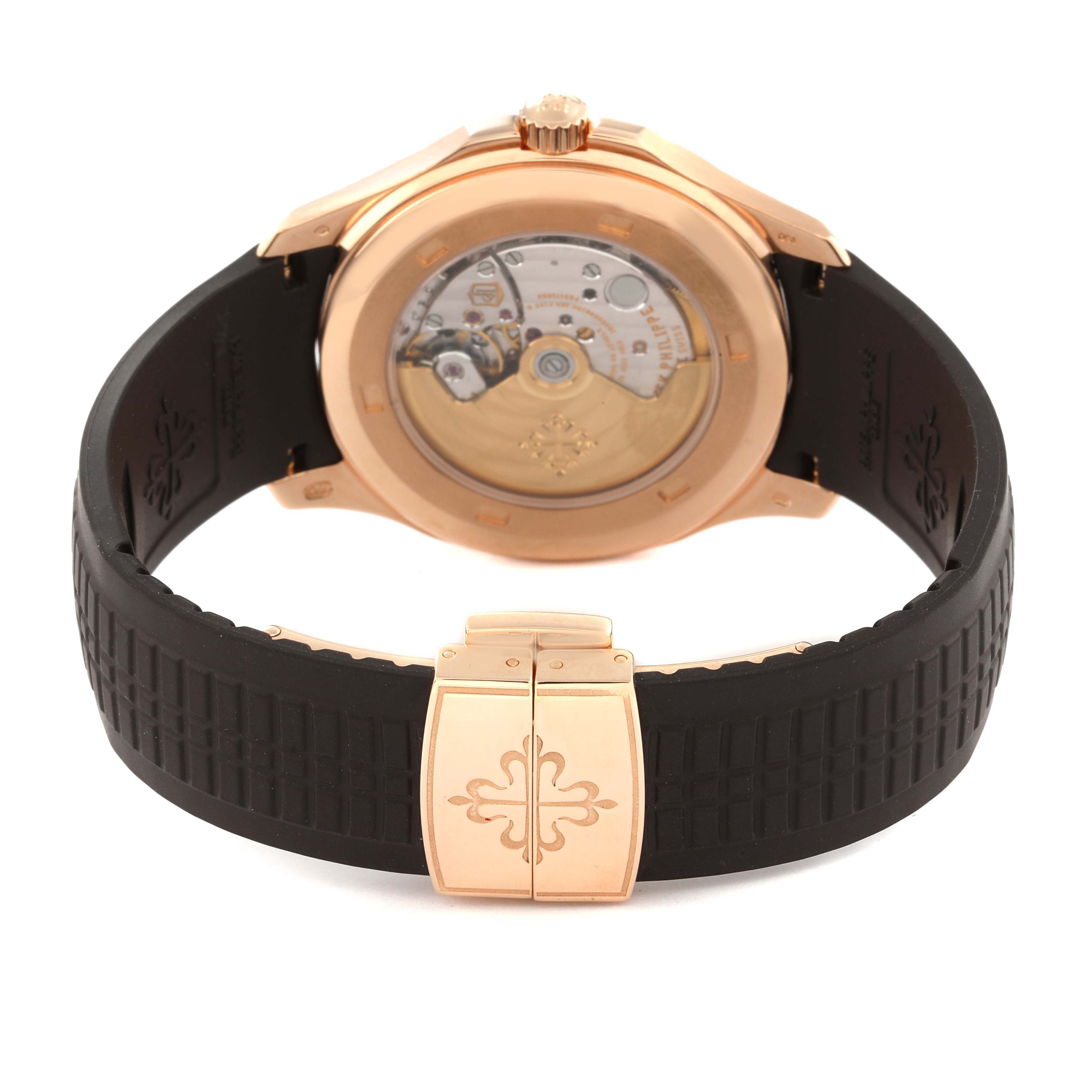 The image shows the back view of the Patek Philippe Aquanaut 5167R-001 Men's Rose Gold Brown Dial 5167R-001 Men's Rose Gold Brown Dial watch, highlighting its transparent case back and black rubber strap.