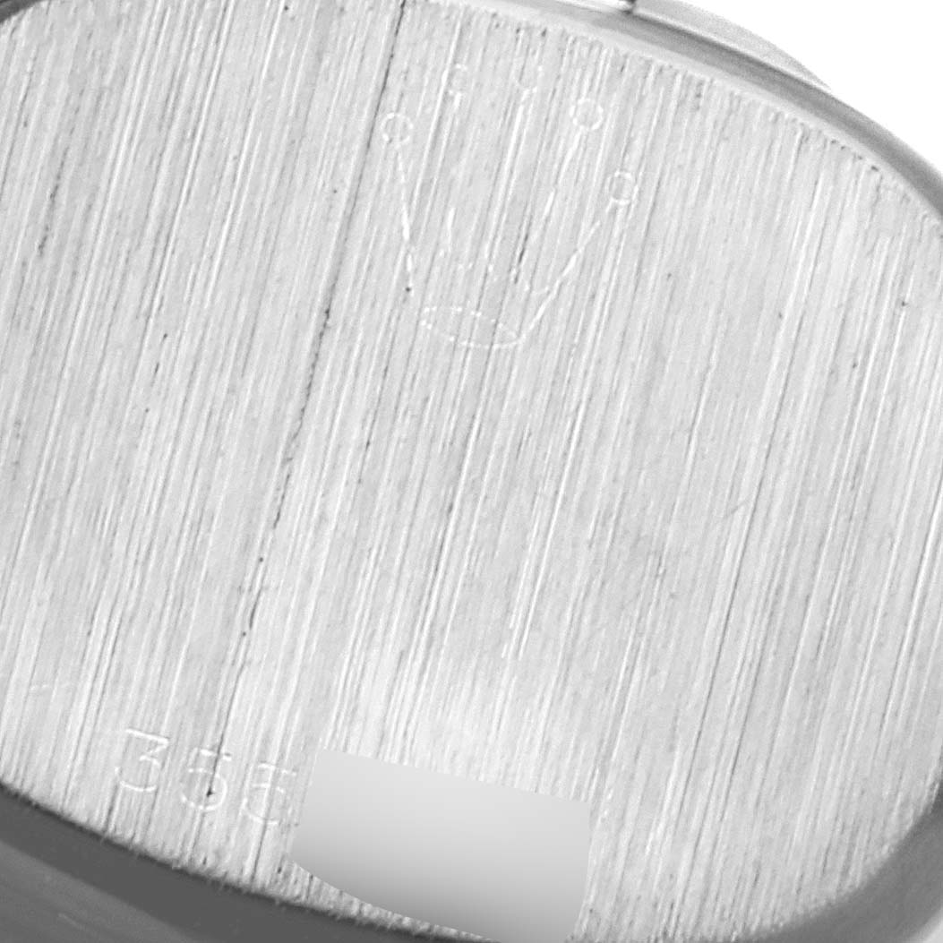 The image shows the case back of a Rolex Cocktail  Women's White Gold Silver Dial  Women's White Gold Silver Dial model watch with minimal angle, displaying its brushed finish and engravings.