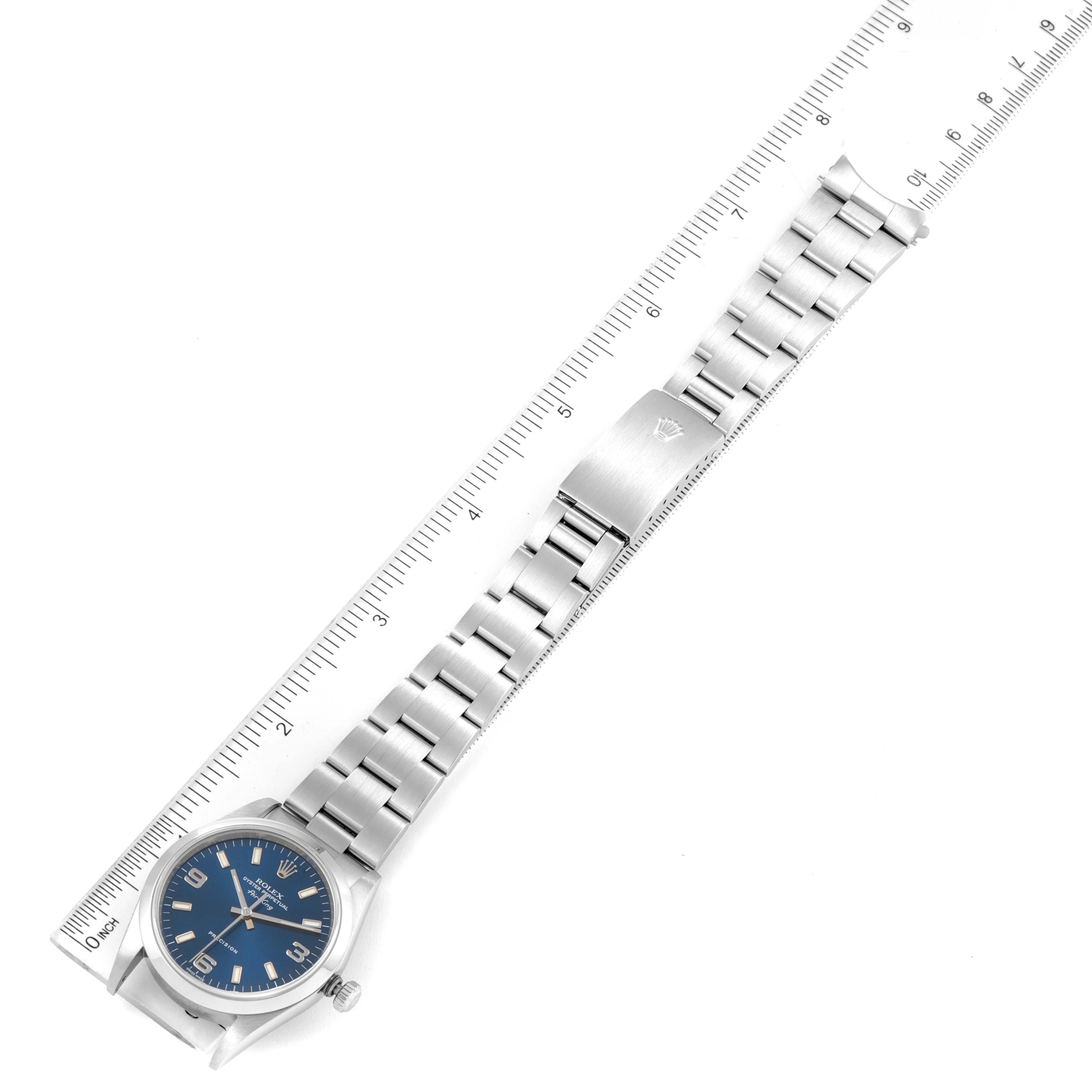 The image shows a top-down angle of a Rolex Air-King 14000 Men's Stainless Steel Blue Dial 14000 Men's Stainless Steel Blue Dial watch, highlighting its band, clasp, blue dial, and case, with a ruler for scale.
