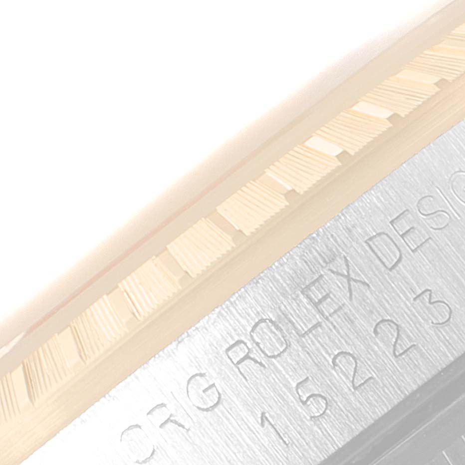 The image shows a close-up of the bezel and case with engraving of a Date model Rolex watch.