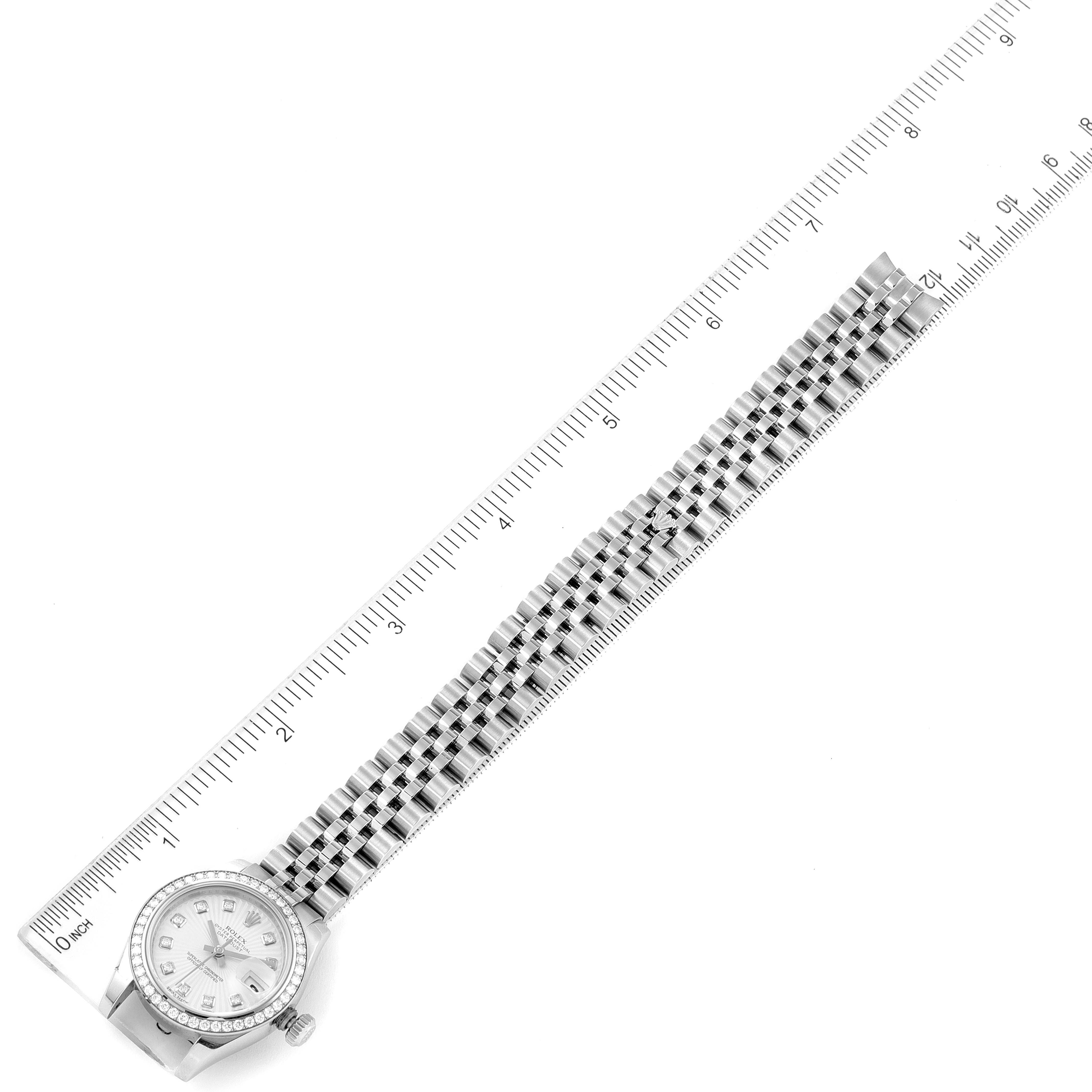 The image shows a top view of a Rolex Datejust 179384 Women's Stainless Steel Silver Dial 179384 Women's Stainless Steel Silver Dial watch including its watch face, case, and bracelet, placed alongside a ruler.