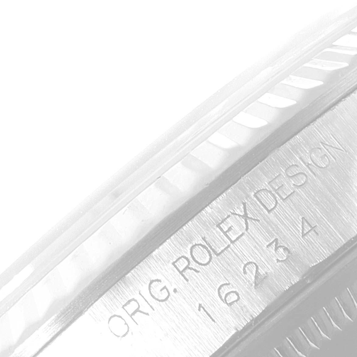 The image shows an angled close-up of the side of a Rolex Datejust 16234 Men's Stainless Steel Silver Dial 16234 Men's Stainless Steel Silver Dial watch, featuring the bezel and engraved design details.