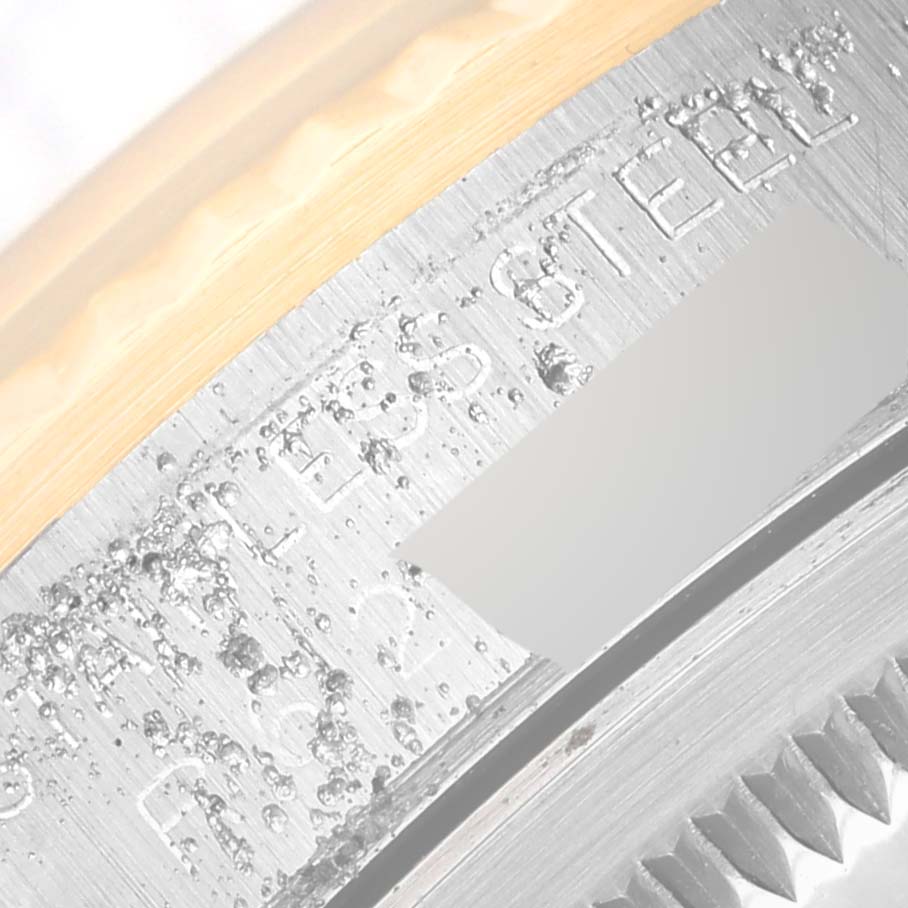 The image shows an extreme close-up of the casing and fluted bezel of the Rolex Datejust 16233 Men's Steel and Gold (two tone) Black Dial 16233 Men's Steel and Gold (two tone) Black Dial watch.