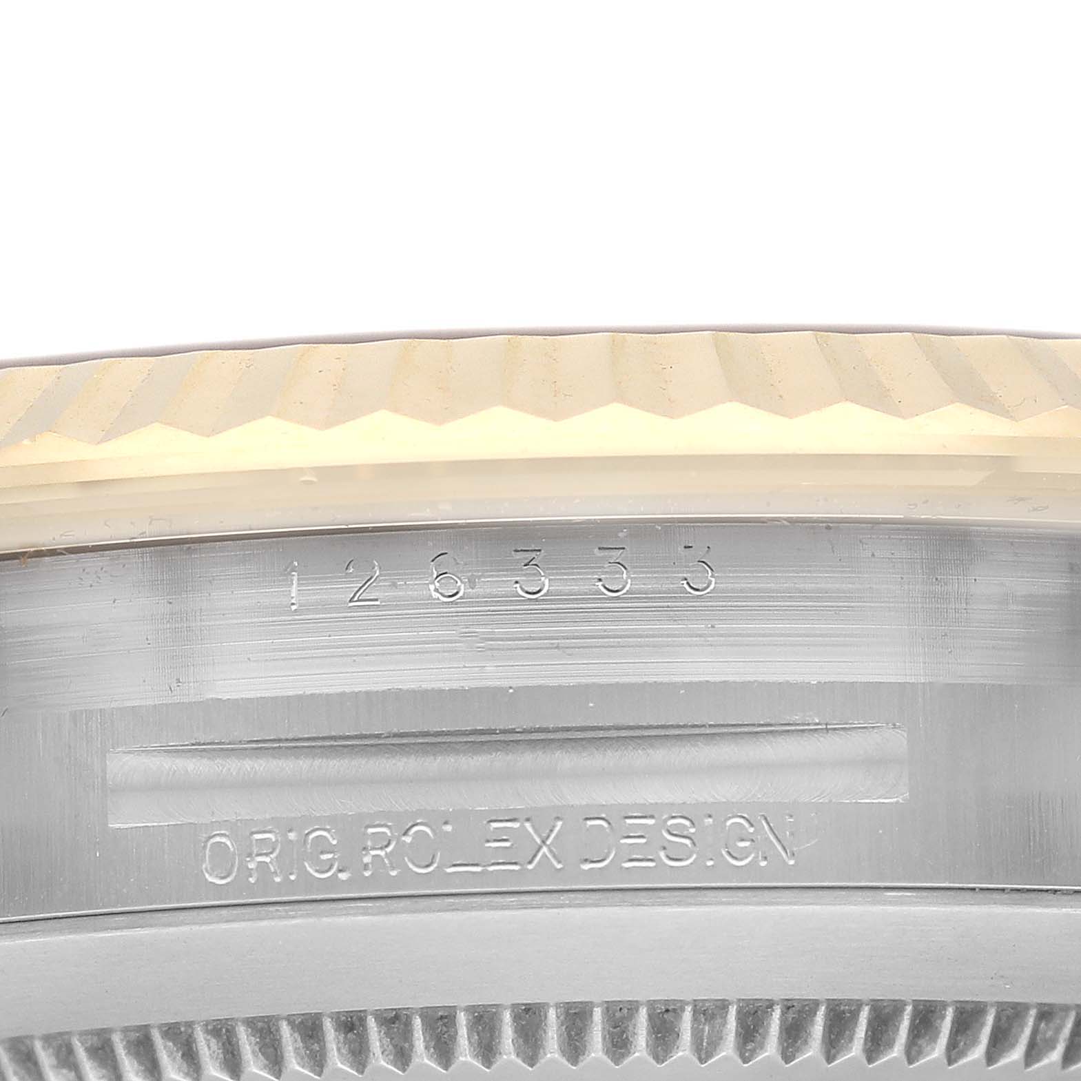 This image shows the serial number and "Orig Rolex Design" engraving on the case of a Rolex Datejust 41 126333 Men's Steel and Gold (two tone) Black Dial 126333 Men's Steel and Gold (two tone) Black Dial watch.