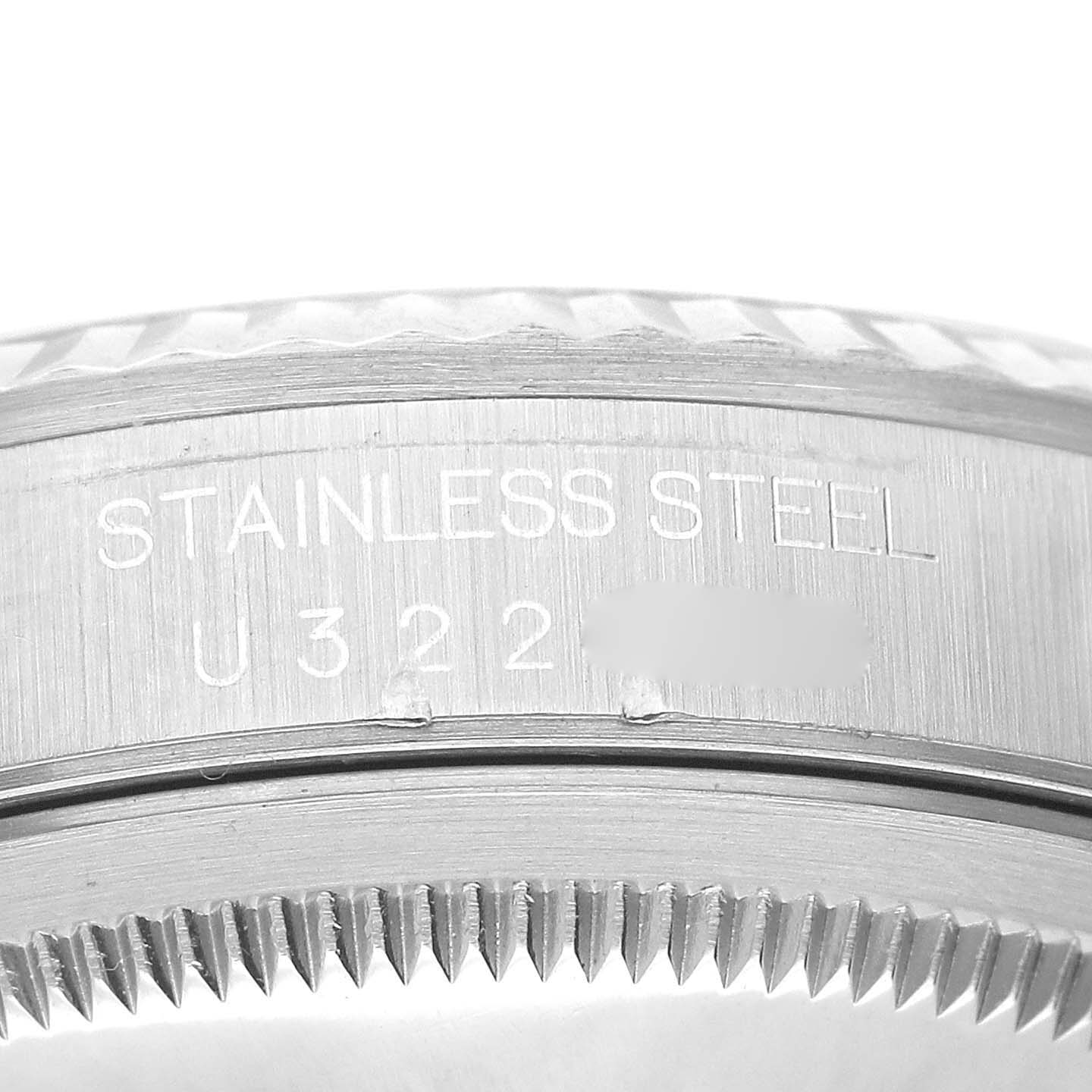 This image shows a close-up of the stainless steel case edge and serial number of a Rolex Datejust 16234 Men's Stainless Steel Blue Dial 16234 Men's Stainless Steel Blue Dial watch.