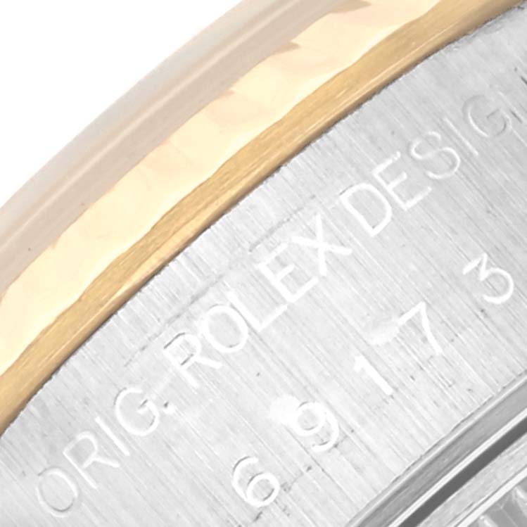 This image shows a close-up of the case side of a Rolex Datejust 69173 Women's Steel and Gold (two tone) Champagne Dial 69173 Women's Steel and Gold (two tone) Champagne Dial watch, featuring the engraved text and part of the bezel.