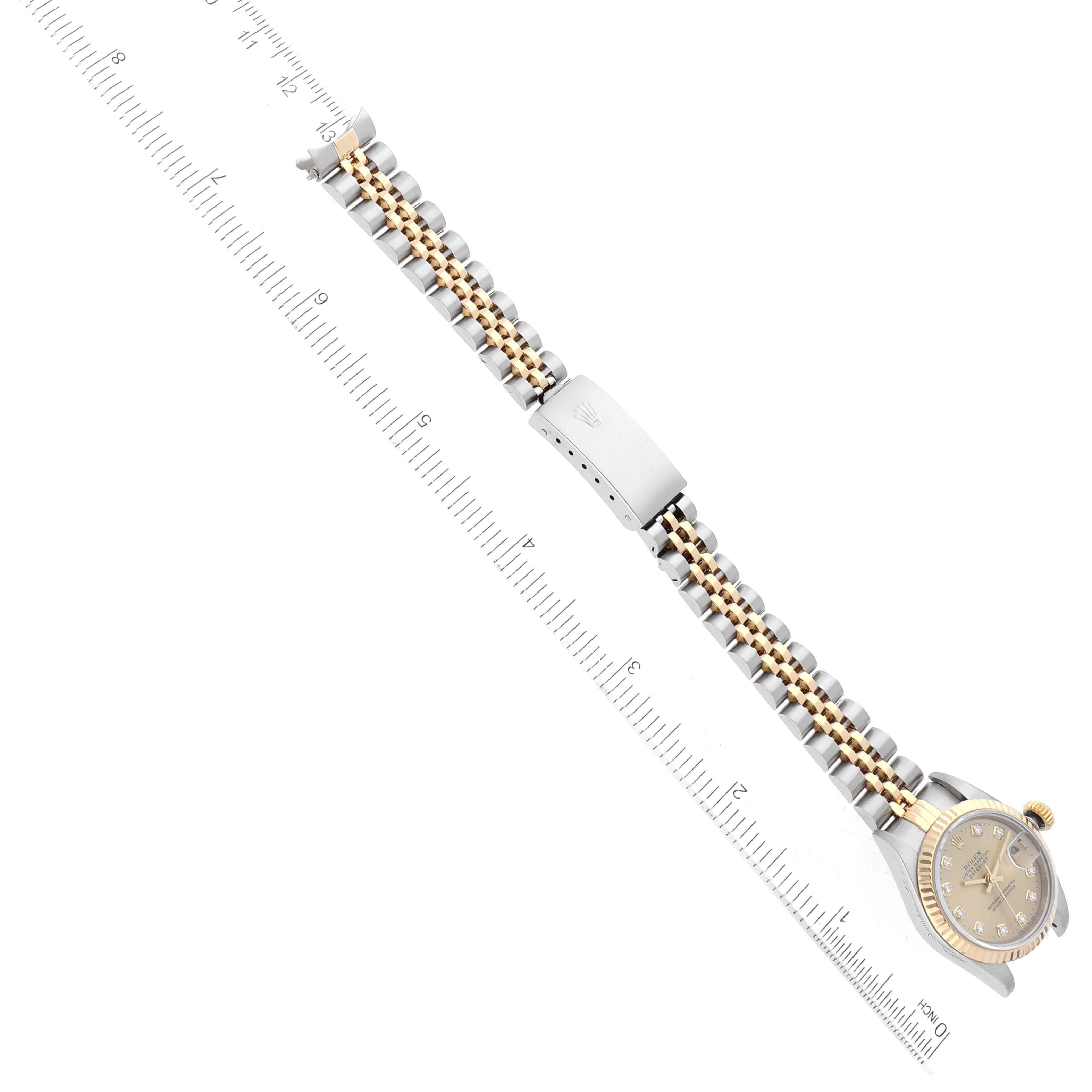 The image shows a Rolex Datejust 69173 Women's Steel and Gold (two tone) Champagne Dial 69173 Women's Steel and Gold (two tone) Champagne Dial watch laid flat, showcasing its band, clasp, and face, measured against a ruler.