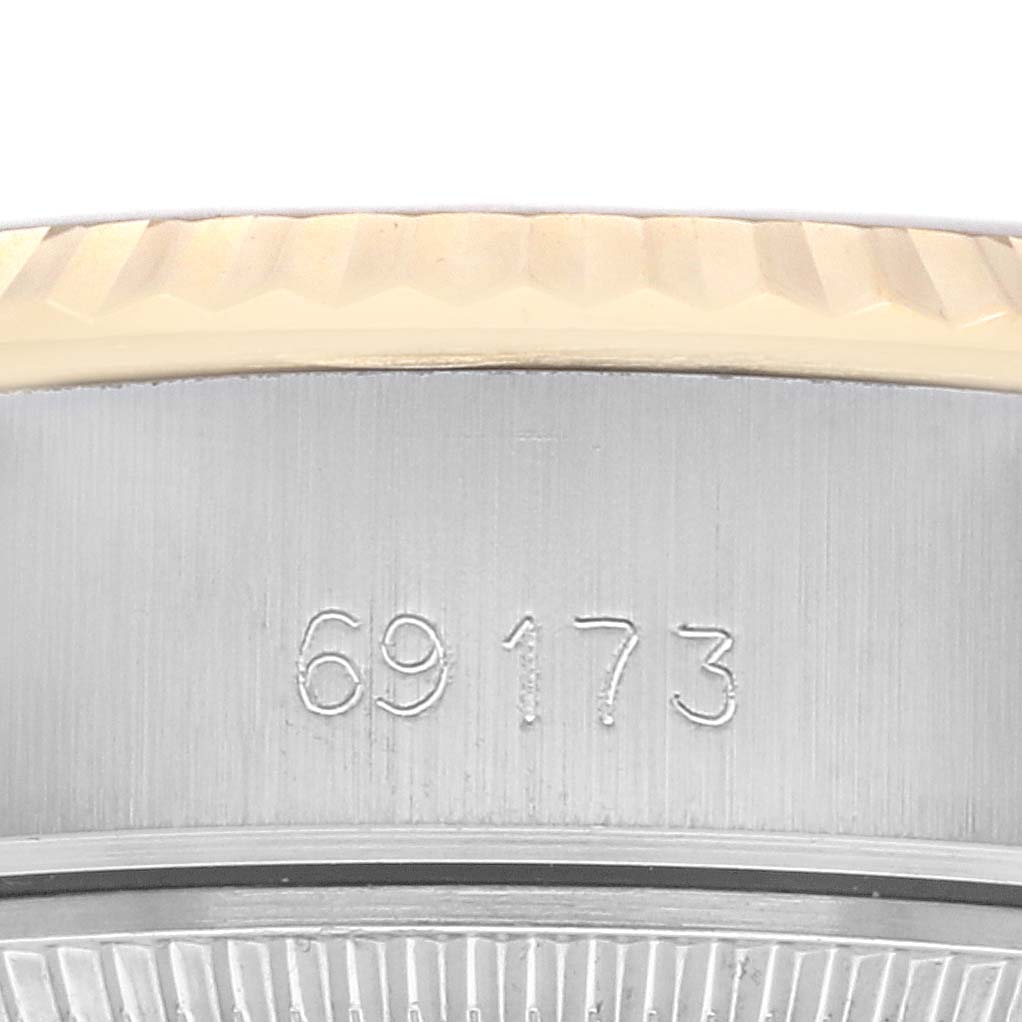 The image shows a close-up of a Rolex Datejust 69173 Women's Steel and Gold (two tone) Champagne Dial 69173 Women's Steel and Gold (two tone) Champagne Dial model, focusing on the engraved serial number on the case.