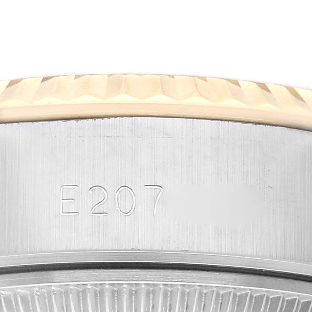 This image shows the edge of the bezel and the serial number on the case of a Rolex Datejust 69173 Women's Steel and Gold (two tone) Champagne Dial 69173 Women's Steel and Gold (two tone) Champagne Dial watch.