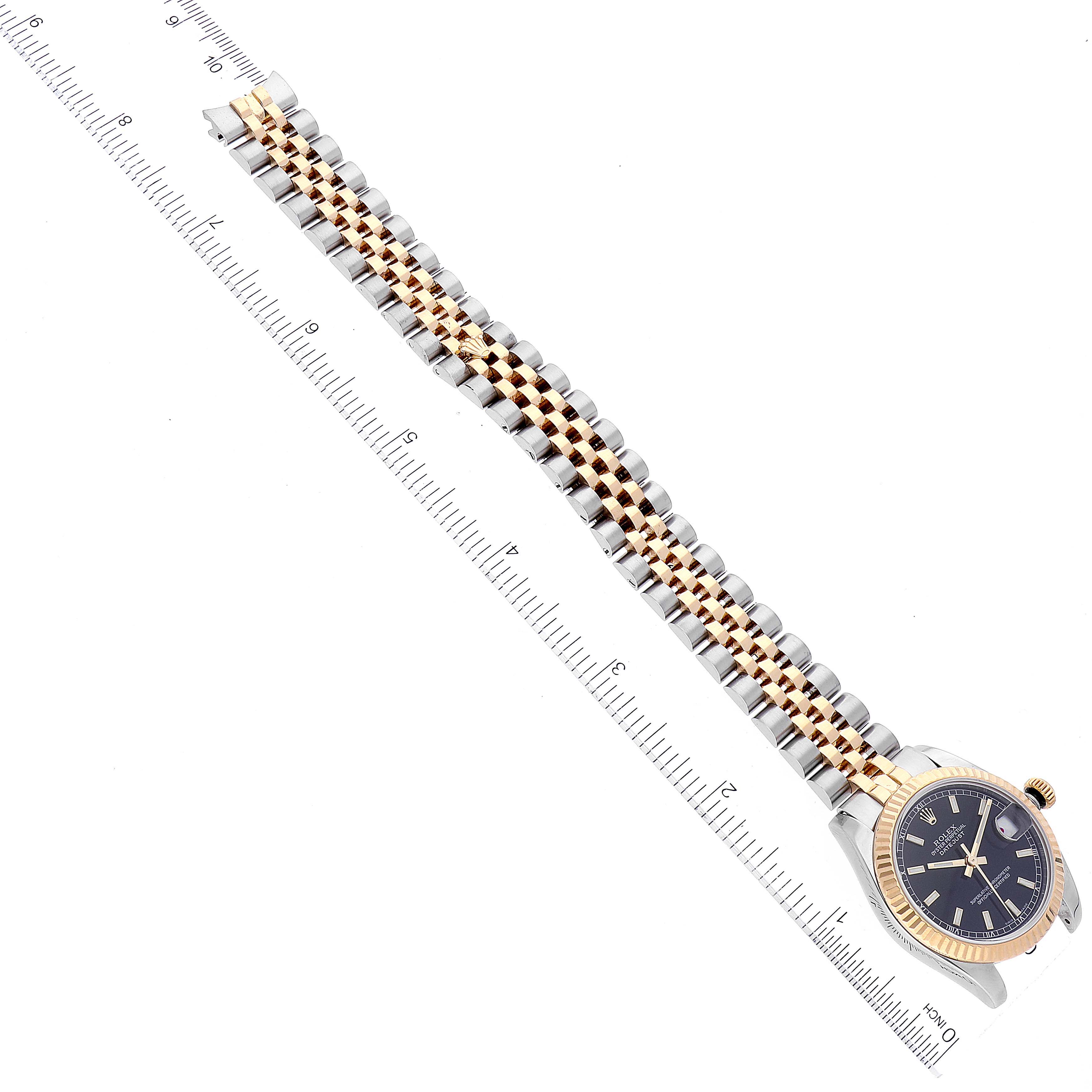 A Rolex Mid-Size 178273 Women
s Steel and Gold (two tone) Black Dial 178273 Women
s Steel and Gold (two tone) Black Dial watch is shown from an overhead angle, displaying the entire band and the bezel.