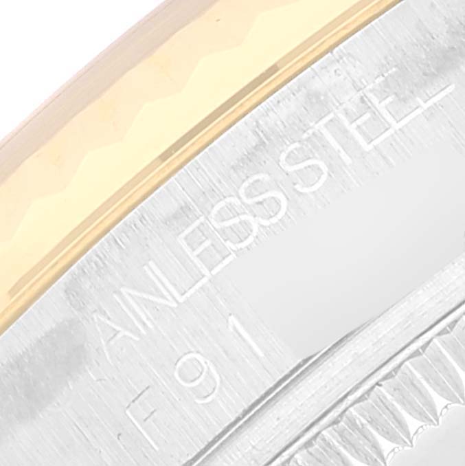This close-up image shows the side engraving of a Rolex Mid-Size 178273 Women
s Steel and Gold (two tone) Black Dial 178273 Women
s Steel and Gold (two tone) Black Dial watch made of stainless steel.