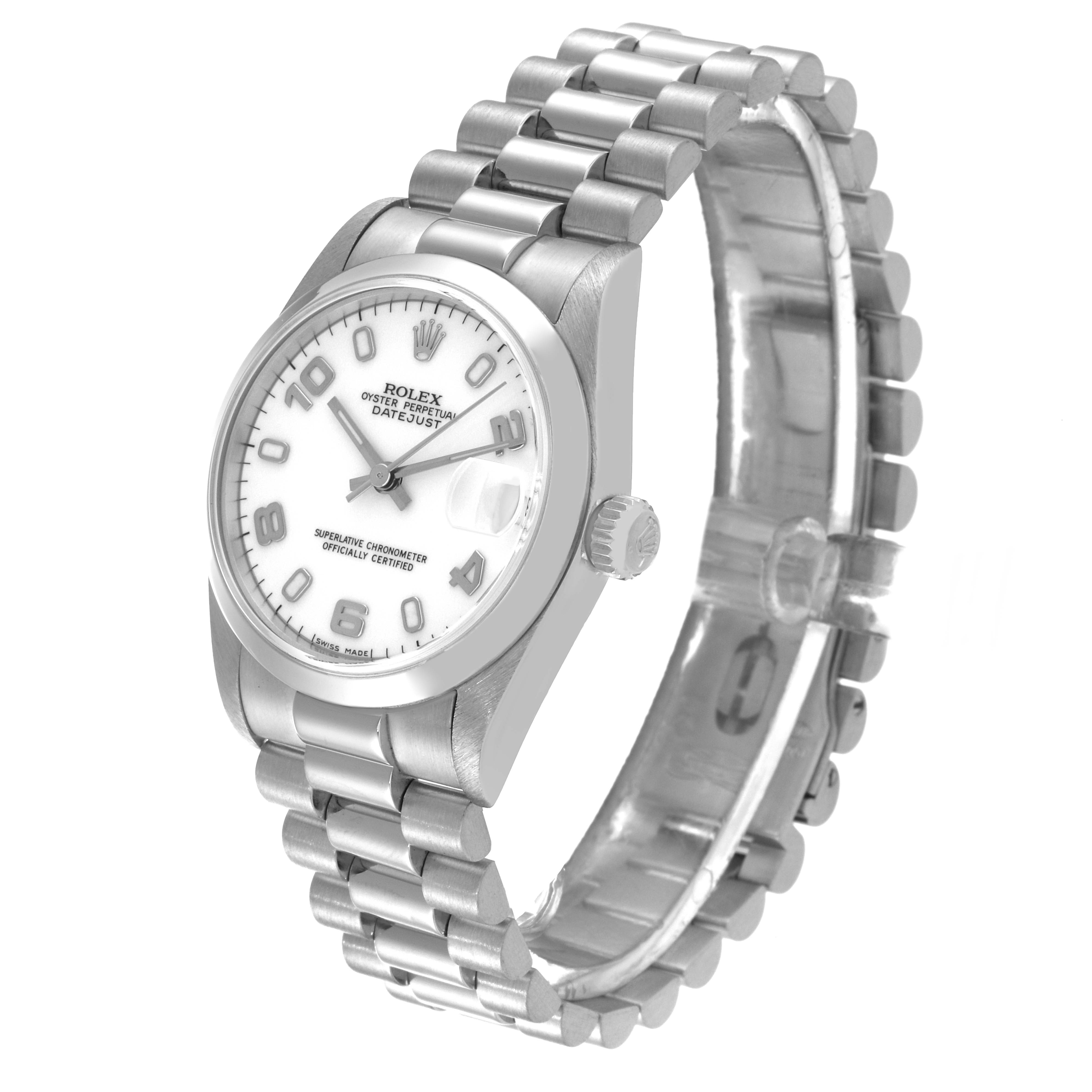 The Mid-Size Rolex watch is shown from a slight angled perspective, displaying the dial, bracelet, and crown.
