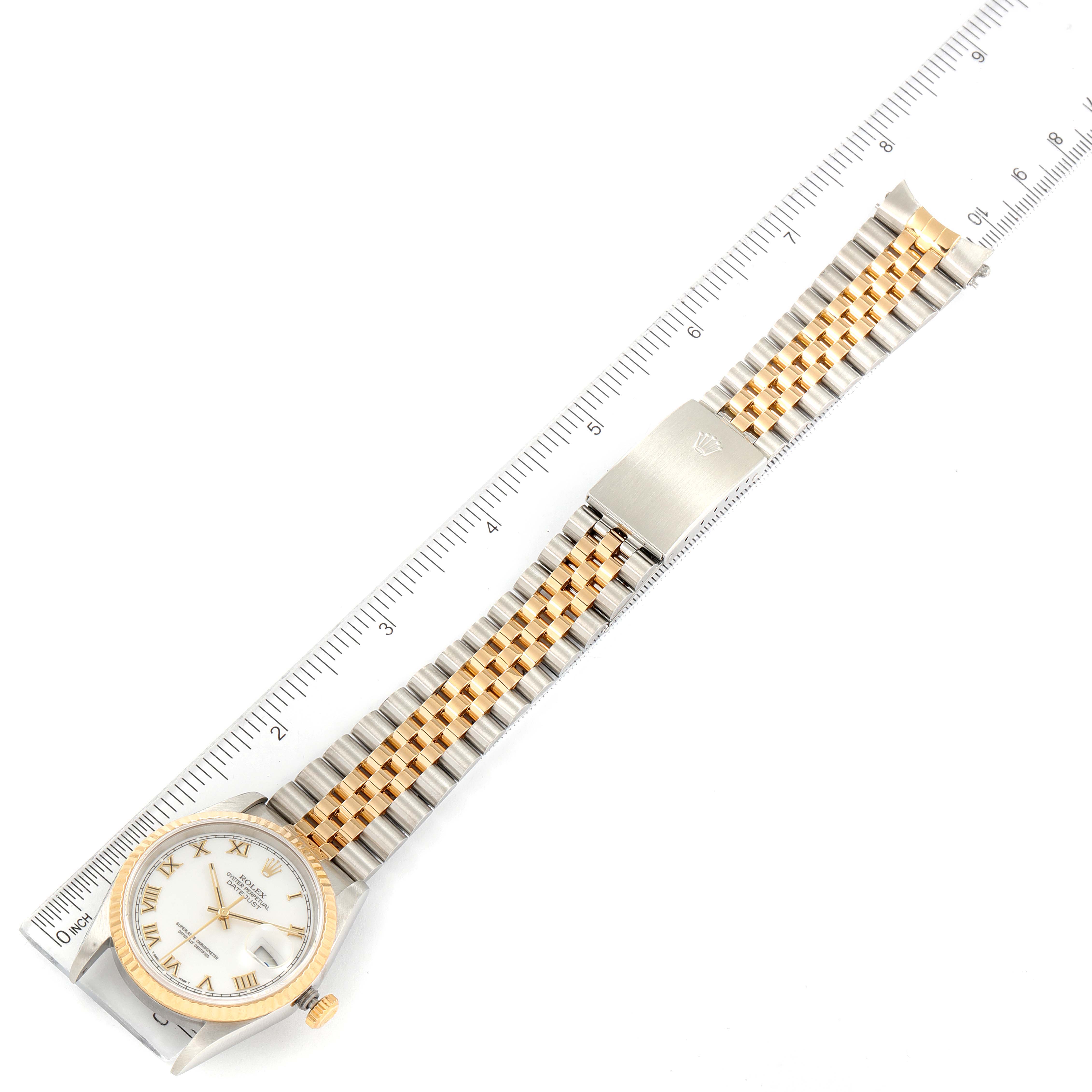 The image shows a top-down view of a Rolex Datejust 16233 Men's Steel and Gold (two tone) White Dial 16233 Men's Steel and Gold (two tone) White Dial watch with a ruler beside it for measurement.