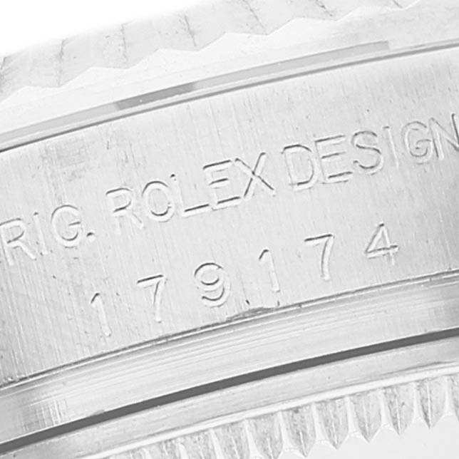 This close-up image shows the engraving on the side of the bezel of a Rolex Datejust 179174 Women's Stainless Steel Silver Dial 179174 Women's Stainless Steel Silver Dial watch.