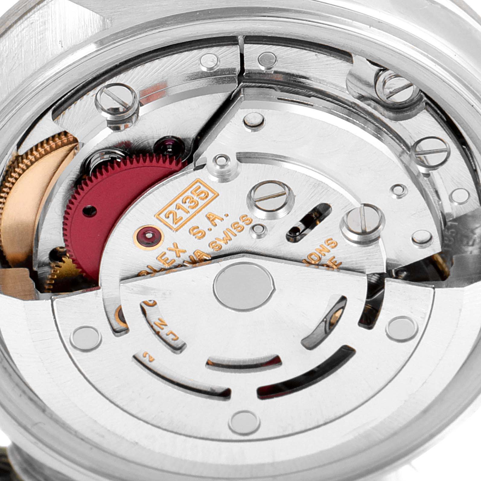 The image shows a close-up of the mechanical movement of a Rolex Datejust 69174 Women
s Stainless Steel Silver Dial 69174 Women
s Stainless Steel Silver Dial watch, highlighting its intricate inner workings.