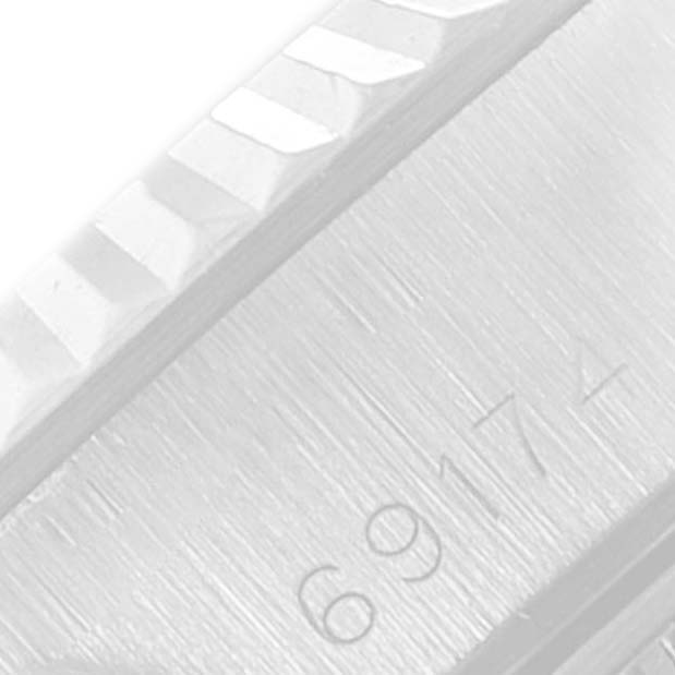 This close-up image shows the fluted bezel and engraved serial number on a Rolex Datejust 69174 Women
s Stainless Steel Silver Dial 69174 Women
s Stainless Steel Silver Dial watch.