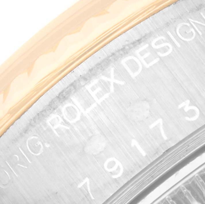 This image shows a close-up of the engraved side of a Rolex Datejust 79173G Women's Steel and Gold (two tone) Champagne Dial 79173G Women's Steel and Gold (two tone) Champagne Dial watch case.