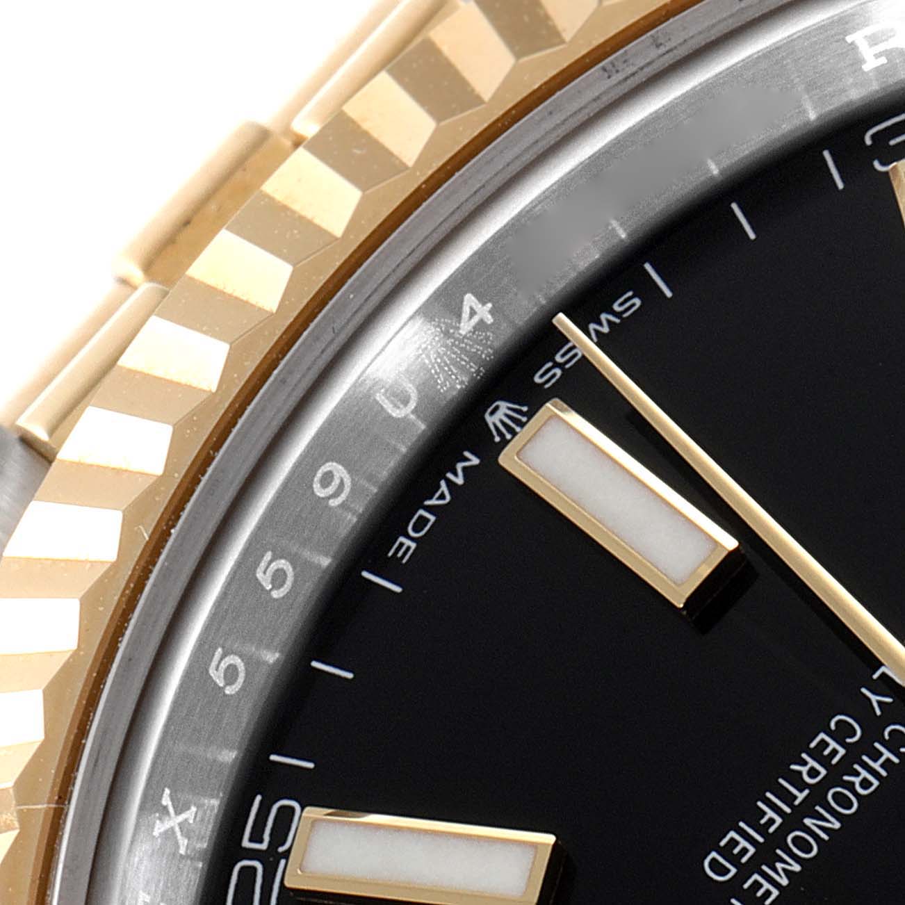 The image shows a close-up angle of the bezel and part of the dial of a Rolex Datejust 41 126233 Men's Steel and Gold (two tone) Black Dial 126233 Men's Steel and Gold (two tone) Black Dial watch.