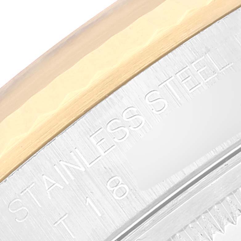 The image shows a close-up of the bezel and engraved text on the case back of a Rolex Datejust 16233 Men's Steel and Gold (two tone) Black Dial 16233 Men's Steel and Gold (two tone) Black Dial watch.