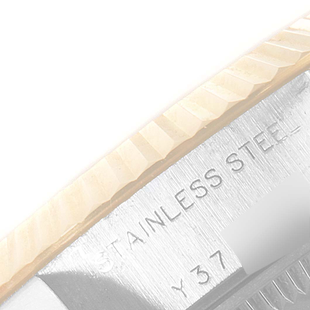 This close-up shows the fluted bezel and part of the case back engraving of a Rolex Datejust 79173 Women's Steel and Gold (two tone) Blue Dial 79173 Women's Steel and Gold (two tone) Blue Dial model, highlighting "stainless steel."