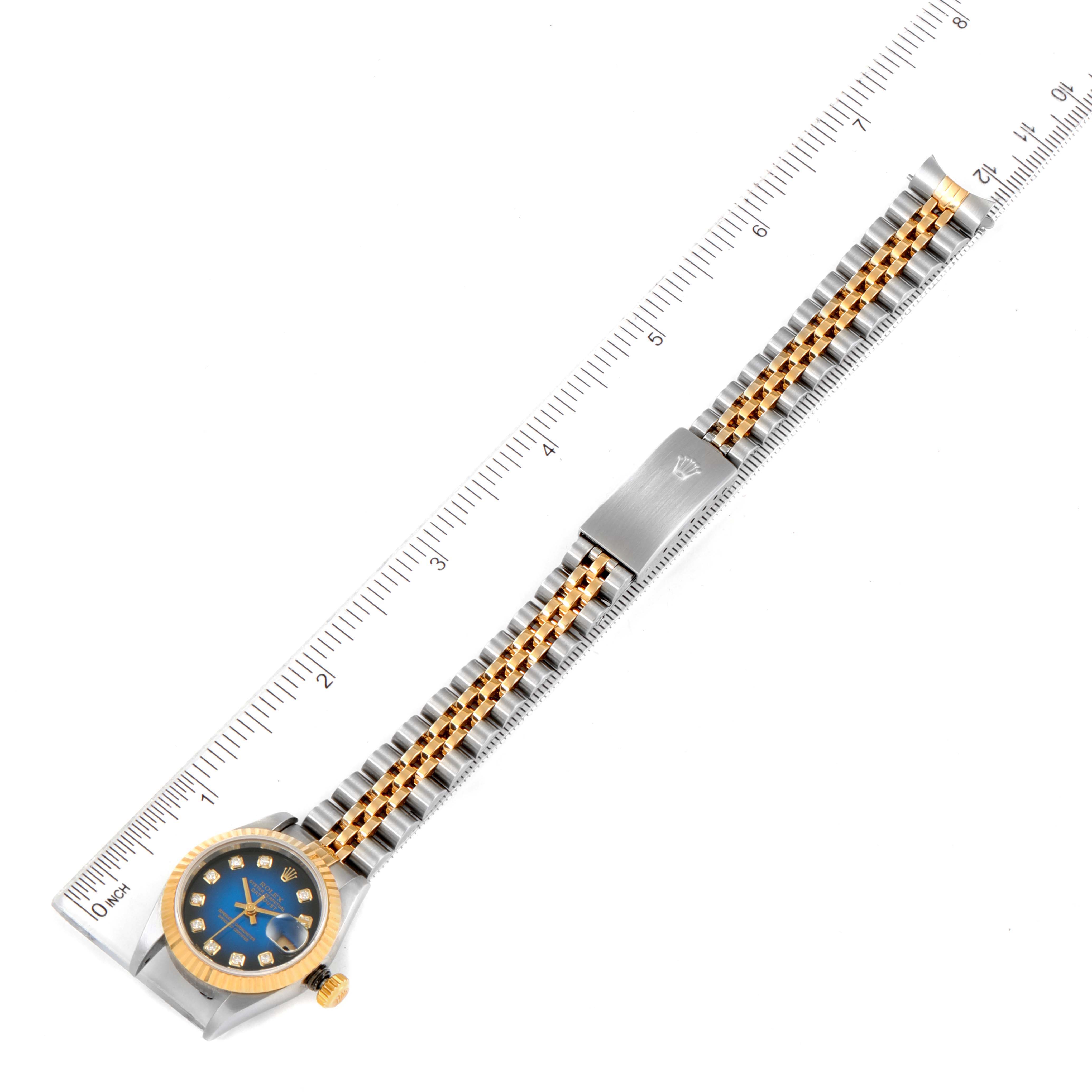 The Rolex Datejust 79173 Women's Steel and Gold (two tone) Blue Dial 79173 Women's Steel and Gold (two tone) Blue Dial watch is displayed fully extended, showing the face, bezel, crown, and entire bracelet, measured against a ruler.