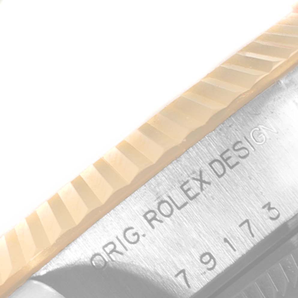 The image shows a close-up of the bezel and the case side of a Rolex Datejust 79173 Women's Steel and Gold (two tone) Blue Dial 79173 Women's Steel and Gold (two tone) Blue Dial watch, focusing on the engraving "ORIG. ROLEX DESIGN."