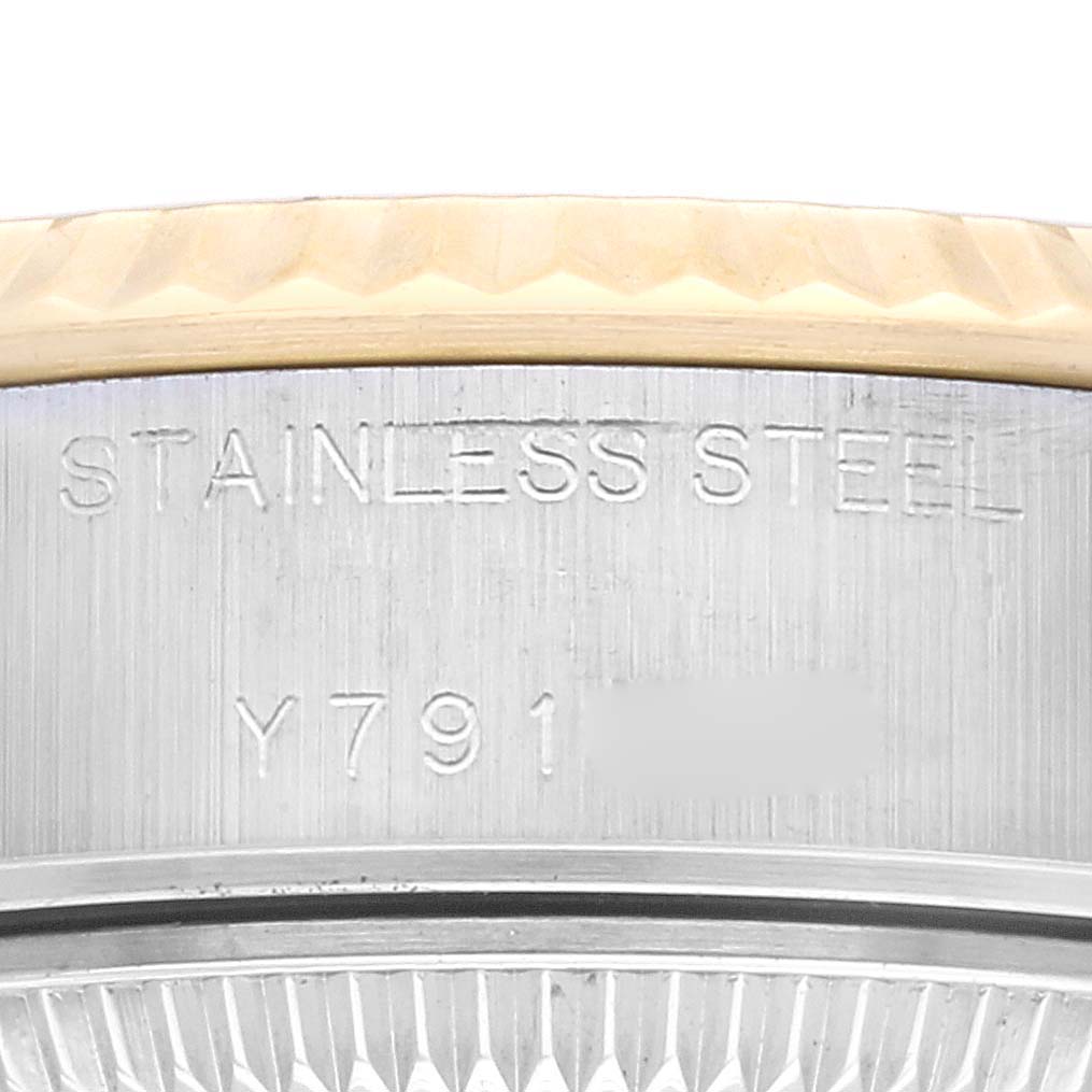 The image shows a close-up view of the stainless steel case and serial number of a Rolex Datejust 79173G Women's Steel and Gold (two tone) Champagne Dial 79173G Women's Steel and Gold (two tone) Champagne Dial watch.