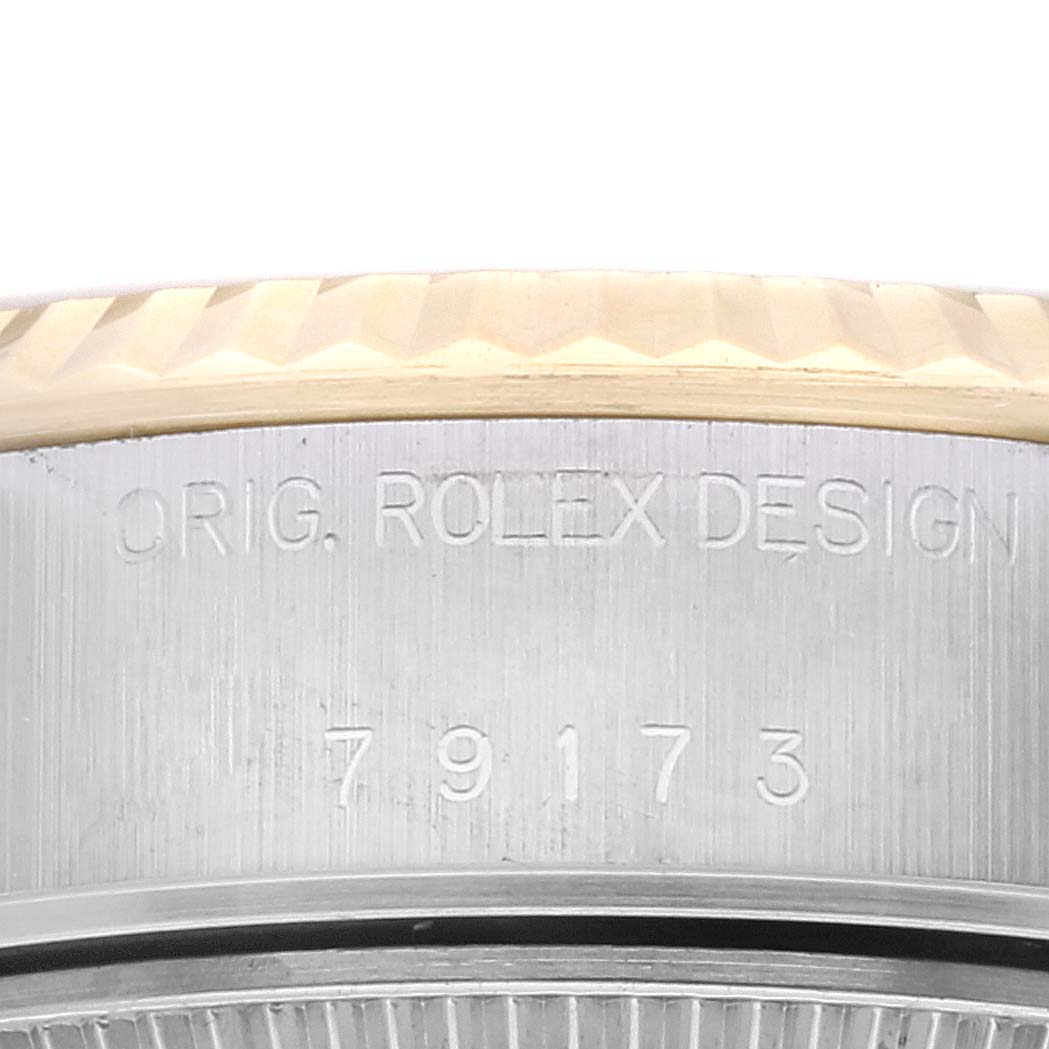 This image shows a close-up of the case side of the Rolex Datejust 79173G Women's Steel and Gold (two tone) Champagne Dial 79173G Women's Steel and Gold (two tone) Champagne Dial, displaying the "ORIG. ROLEX DESIGN" inscription and reference number.