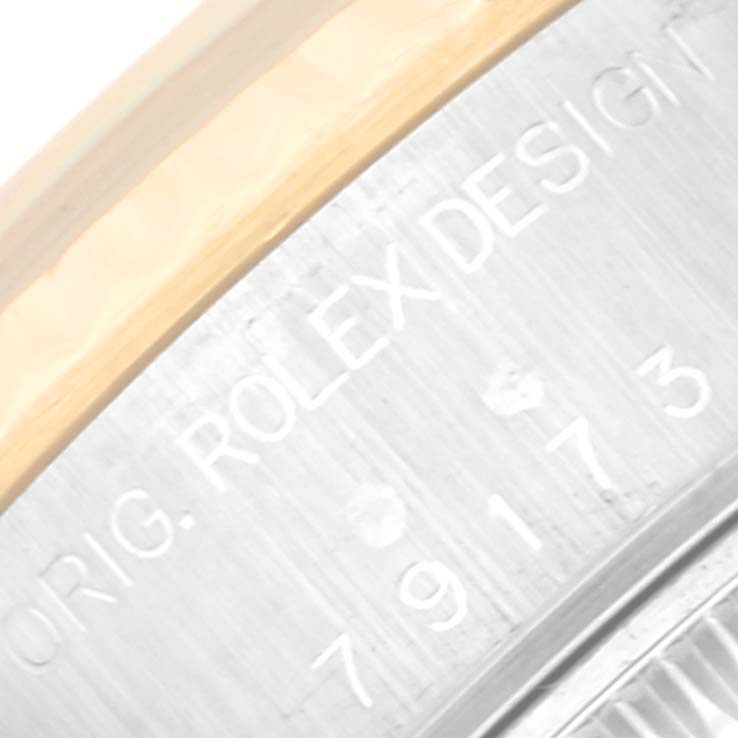 This image shows a close-up of the "ORIG. ROLEX DESIGN" inscription and part of the serial number on a Rolex Datejust 79173G Women's Steel and Gold (two tone) Champagne Dial 79173G Women's Steel and Gold (two tone) Champagne Dial watch.