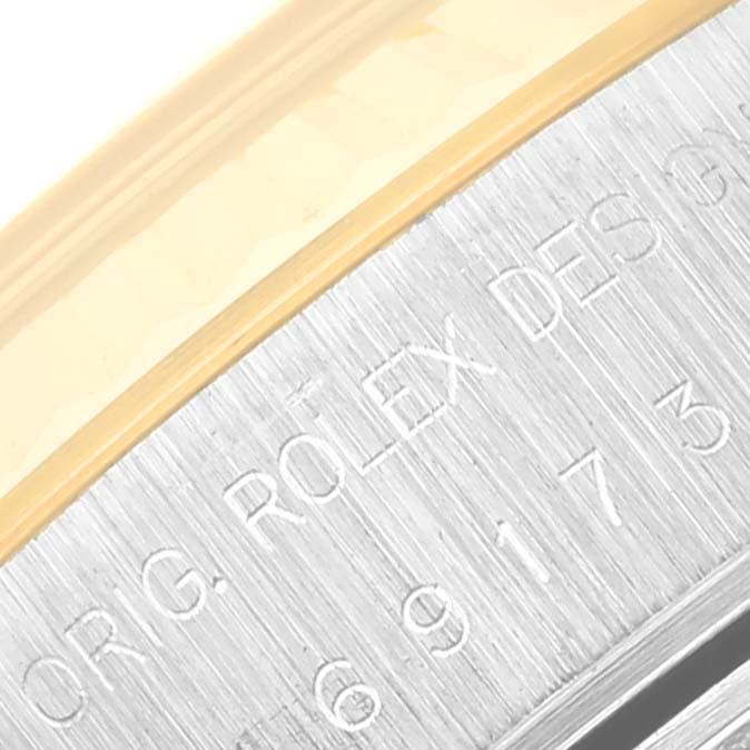 The image shows a close-up angle of the edge of a Rolex Datejust 69173 Women's Steel and Gold (two tone) Champagne Dial 69173 Women's Steel and Gold (two tone) Champagne Dial watch, displaying part of the engraved bezel.