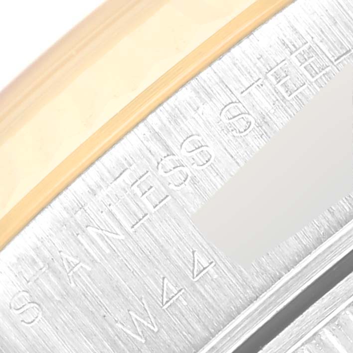 This image shows a close-up of the bezel and case side of a Rolex Datejust 69173 Women's Steel and Gold (two tone) Champagne Dial 69173 Women's Steel and Gold (two tone) Champagne Dial watch with "STAINLESS STEEL" marked.