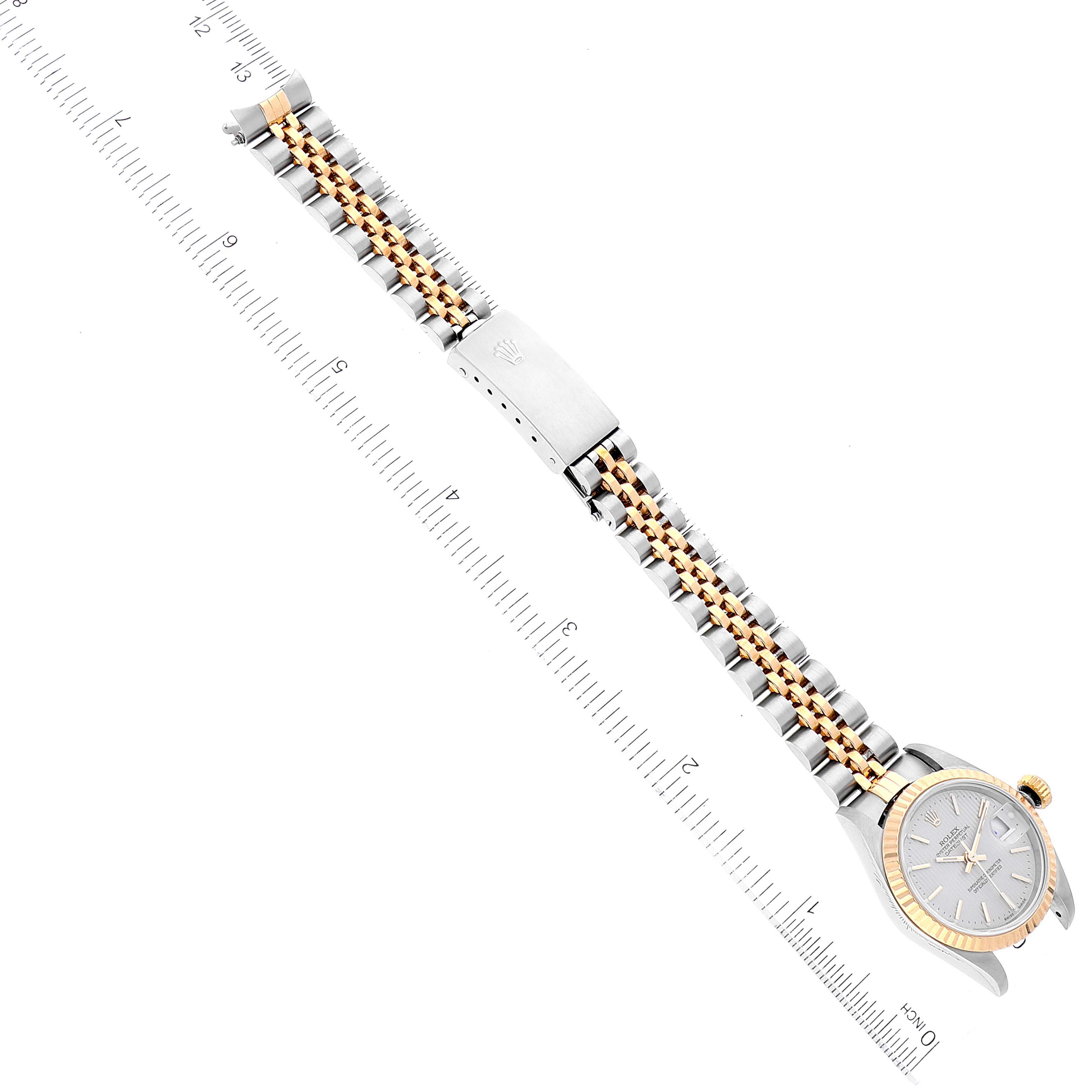 The image shows a Rolex Datejust 79173 Women's Steel and Gold (two tone) Silver Dial 79173 Women's Steel and Gold (two tone) Silver Dial watch laid flat to display the full length of the metal strap and bezel, accompanied by measurement markings.