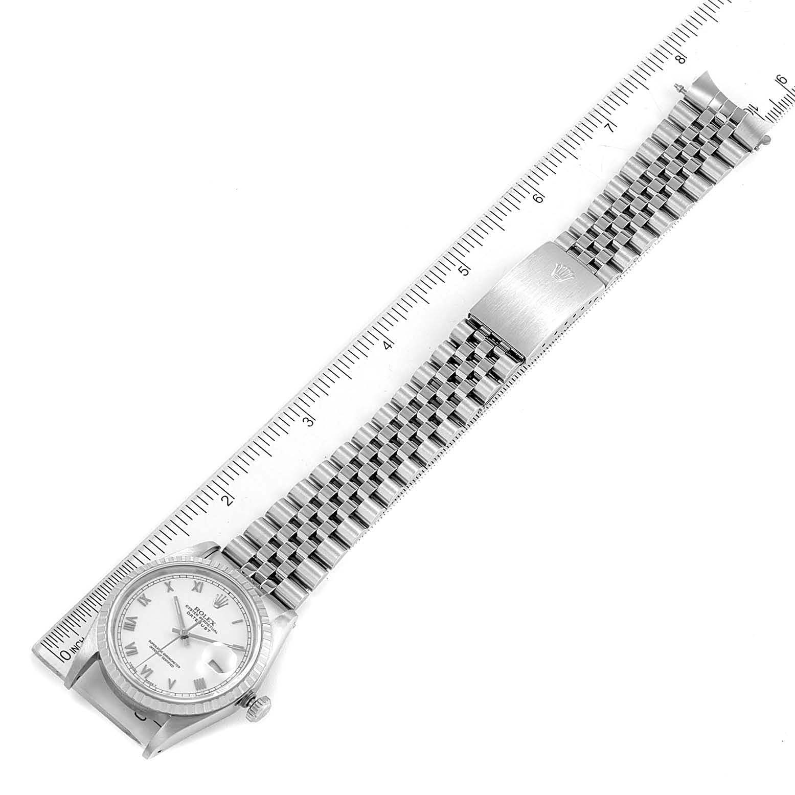 The image shows a Rolex Datejust 16220 Men's Stainless Steel White Dial 16220 Men's Stainless Steel White Dial watch with a full view of the face, bezel, and metal bracelet, aligned with a ruler for scale.