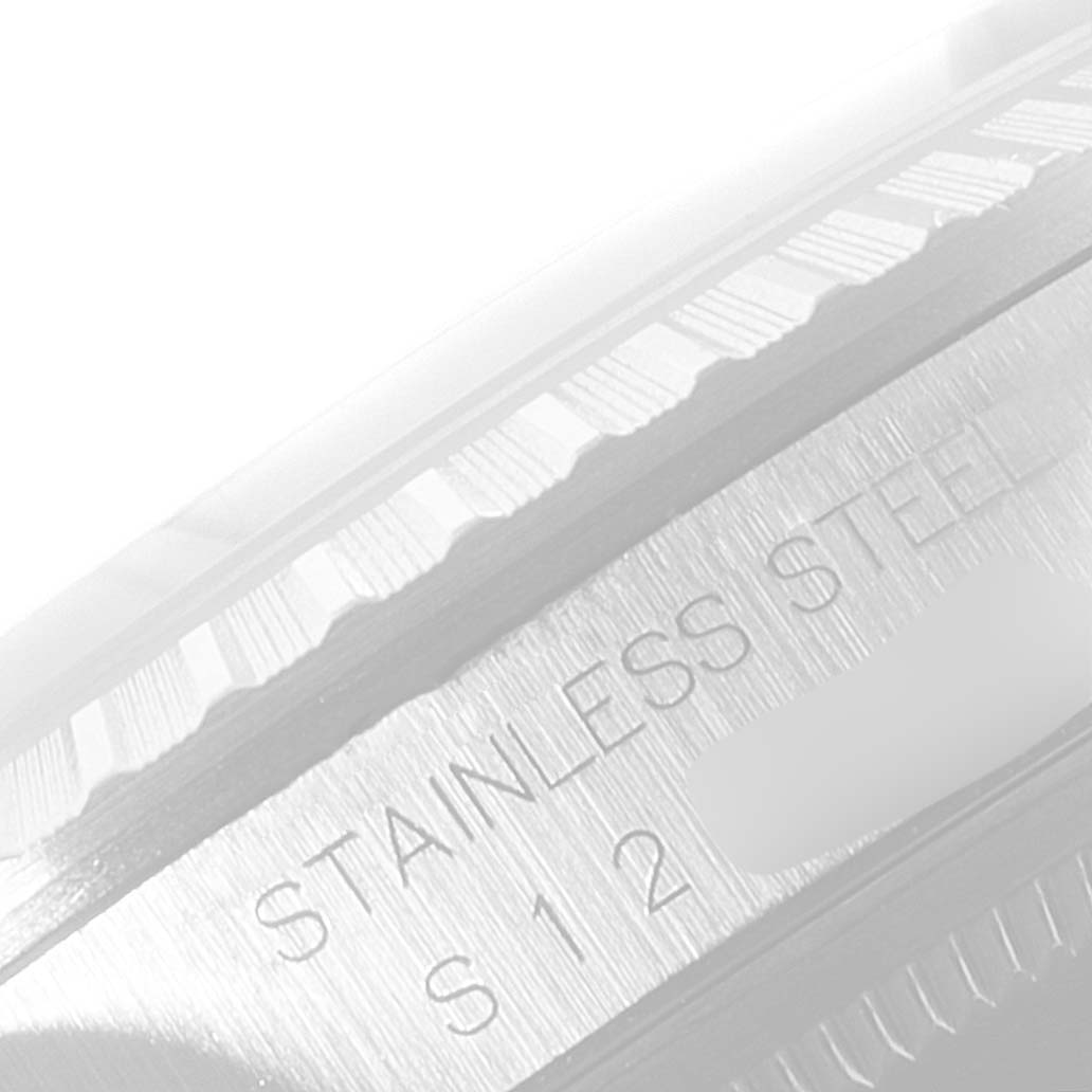 This close-up shows the stainless steel bezel and part of the case of the Rolex Datejust 16220 Men's Stainless Steel White Dial 16220 Men's Stainless Steel White Dial watch.